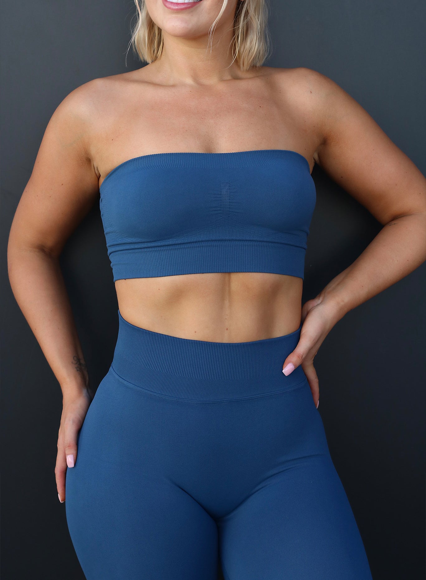 front profile view of a model wearing our seamless bandeau in galaxy color along with the matching leggings