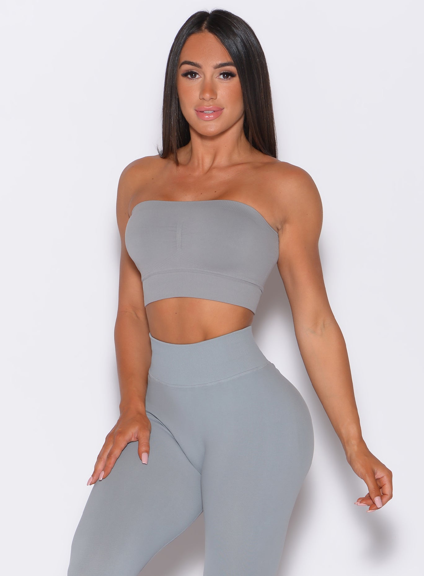 front profile view of a model in our seamless bandeau in fog gray color along with the matching leggings