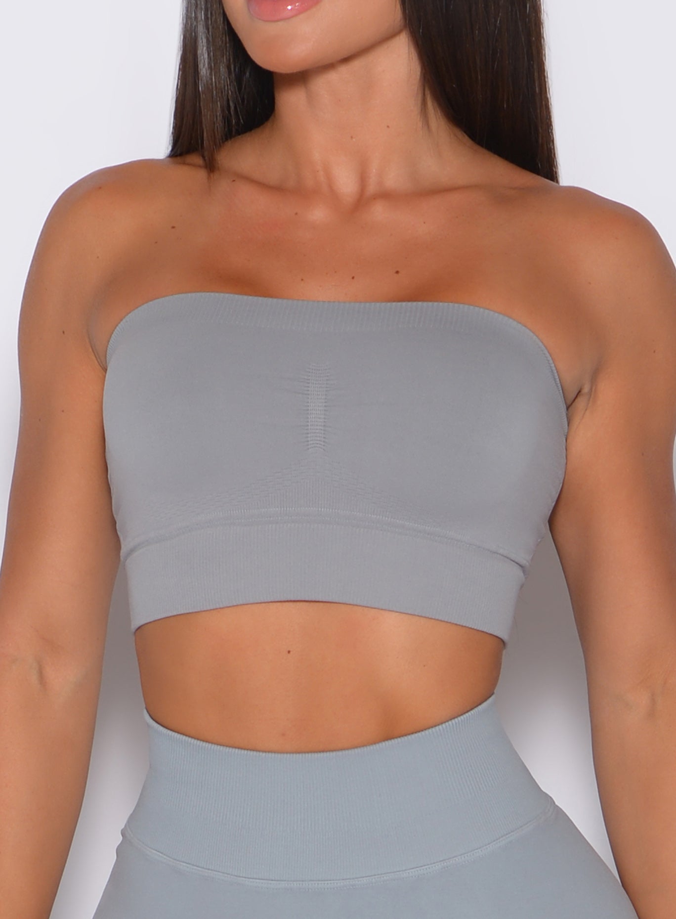 zoomed in front view of a model wearing our seamless bandeau in fog gray color