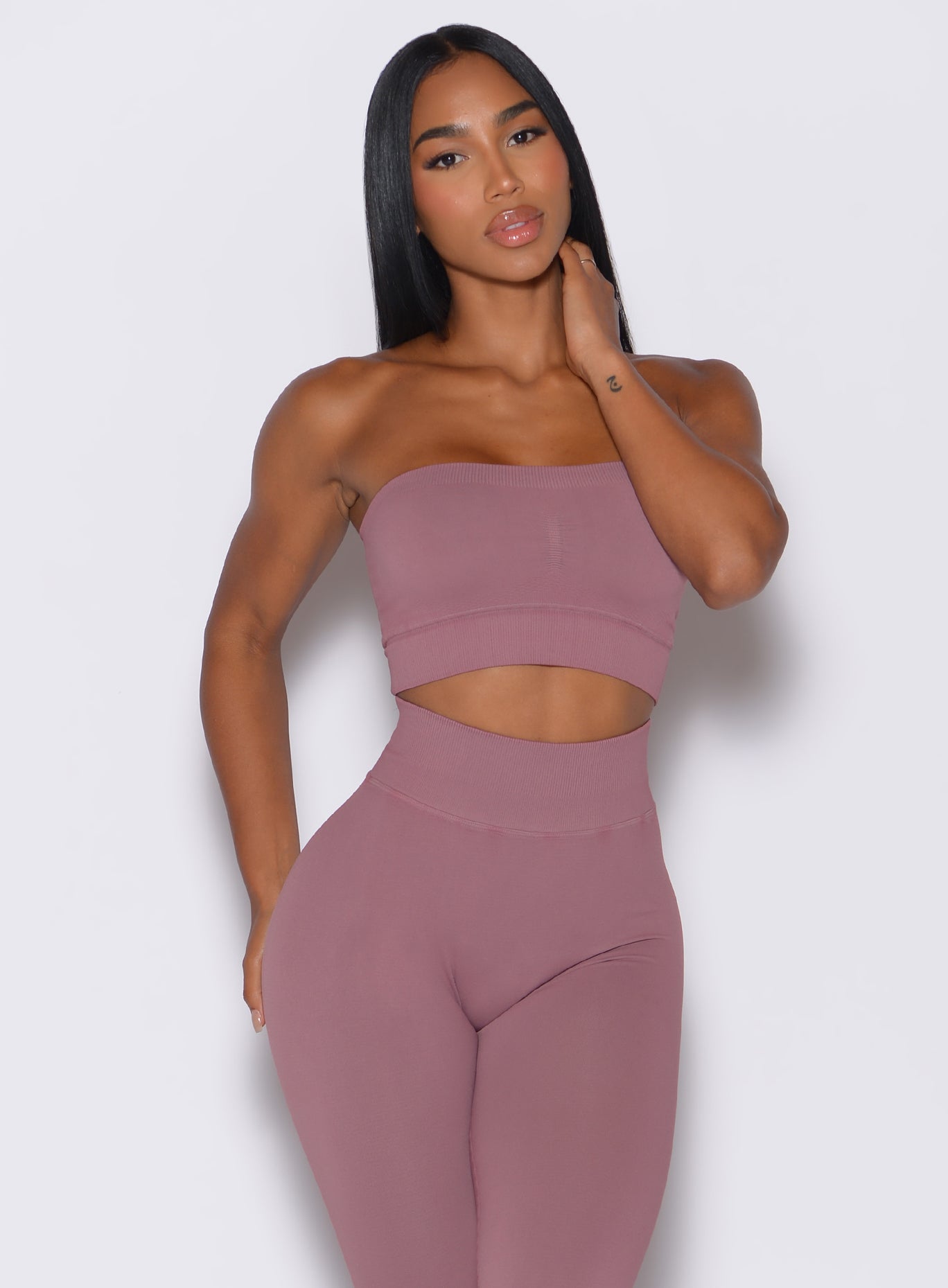 front profile view of a model in our seamless bandeau in satin color along with the matching leggings