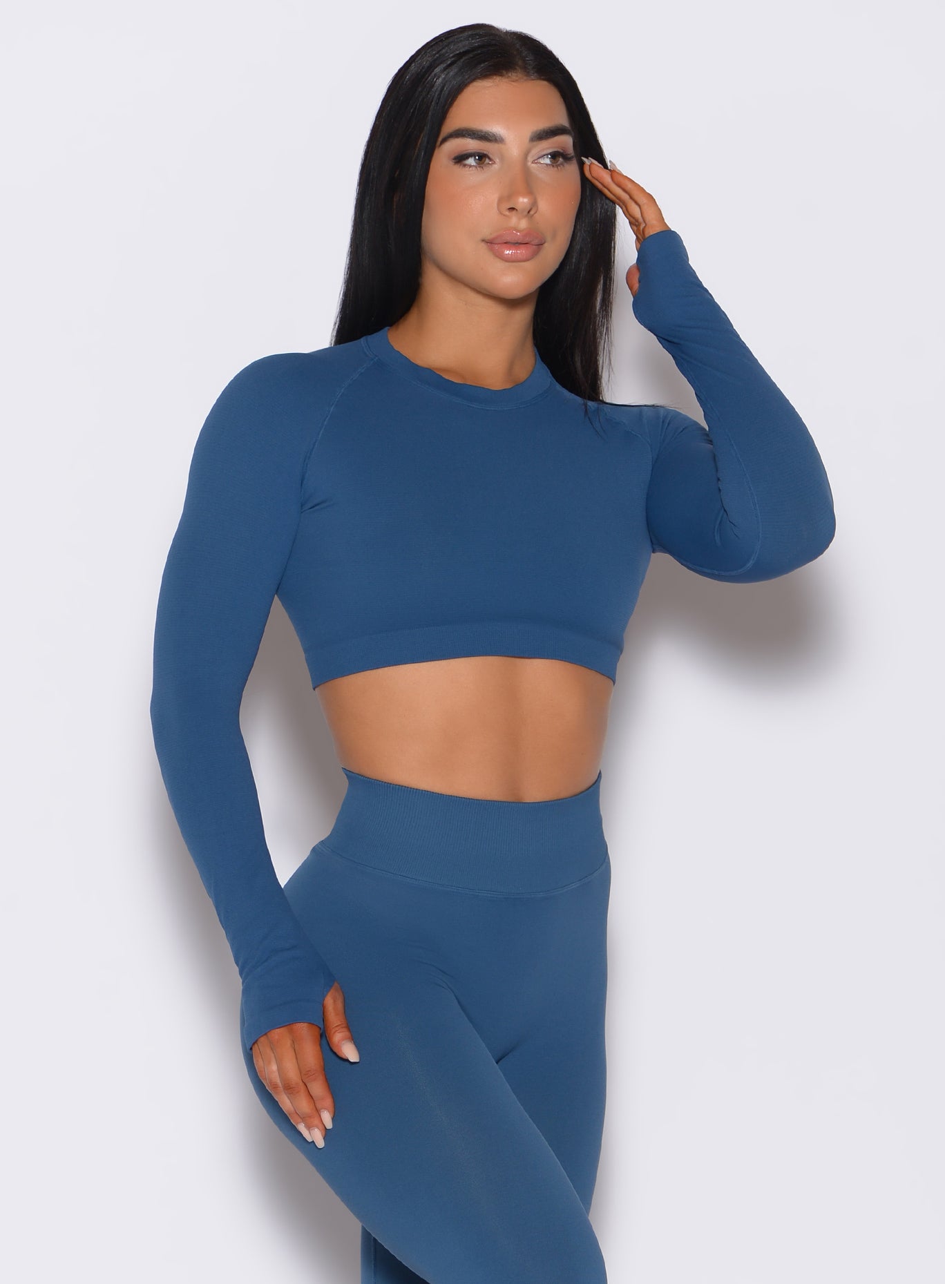 front profile view of a model wearing our seamless pullover in galaxy color along with a matching leggings