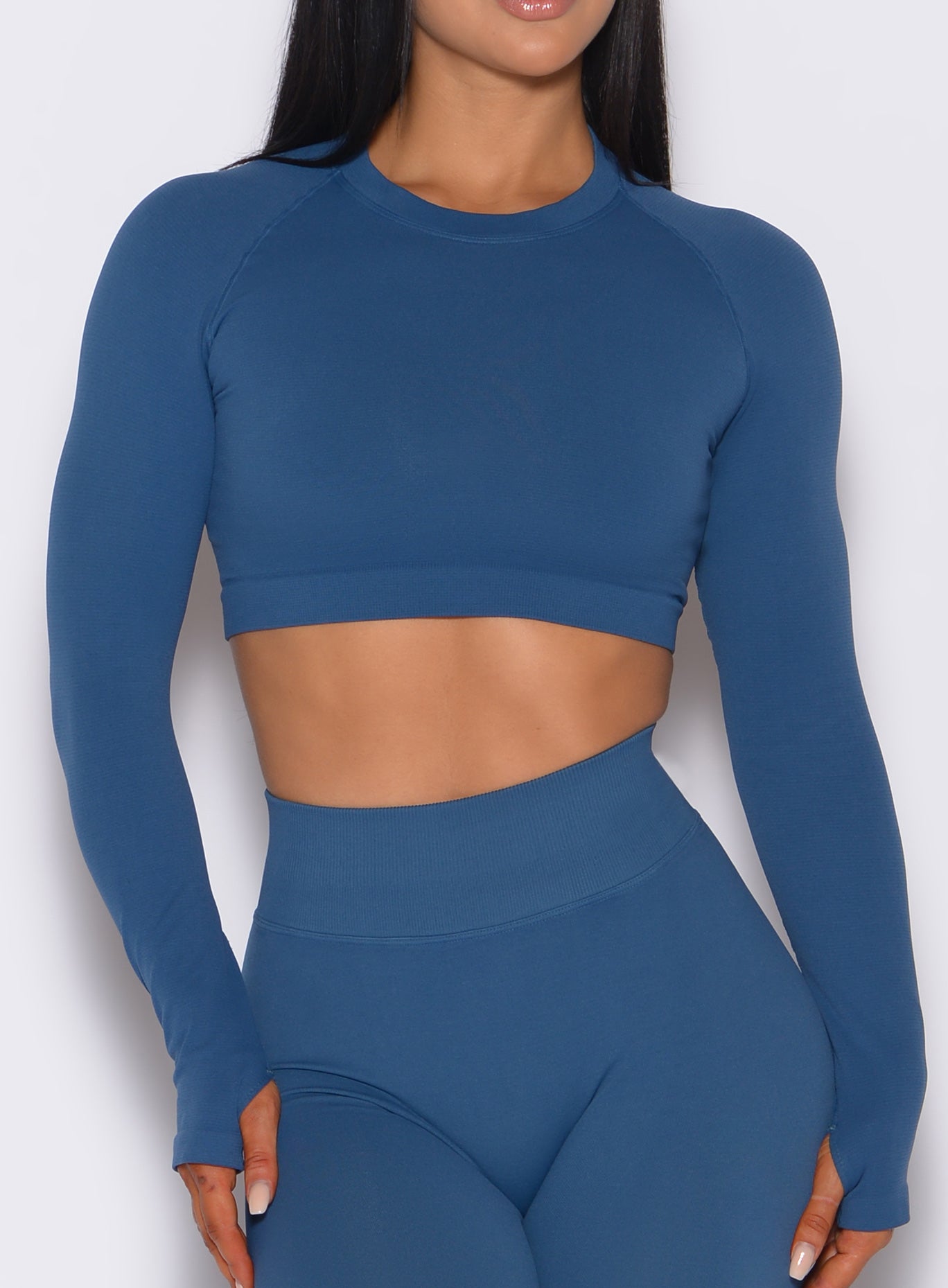 zoomed in front profile view of a model wearing our seamless pullover in galaxy color along with a matching leggings