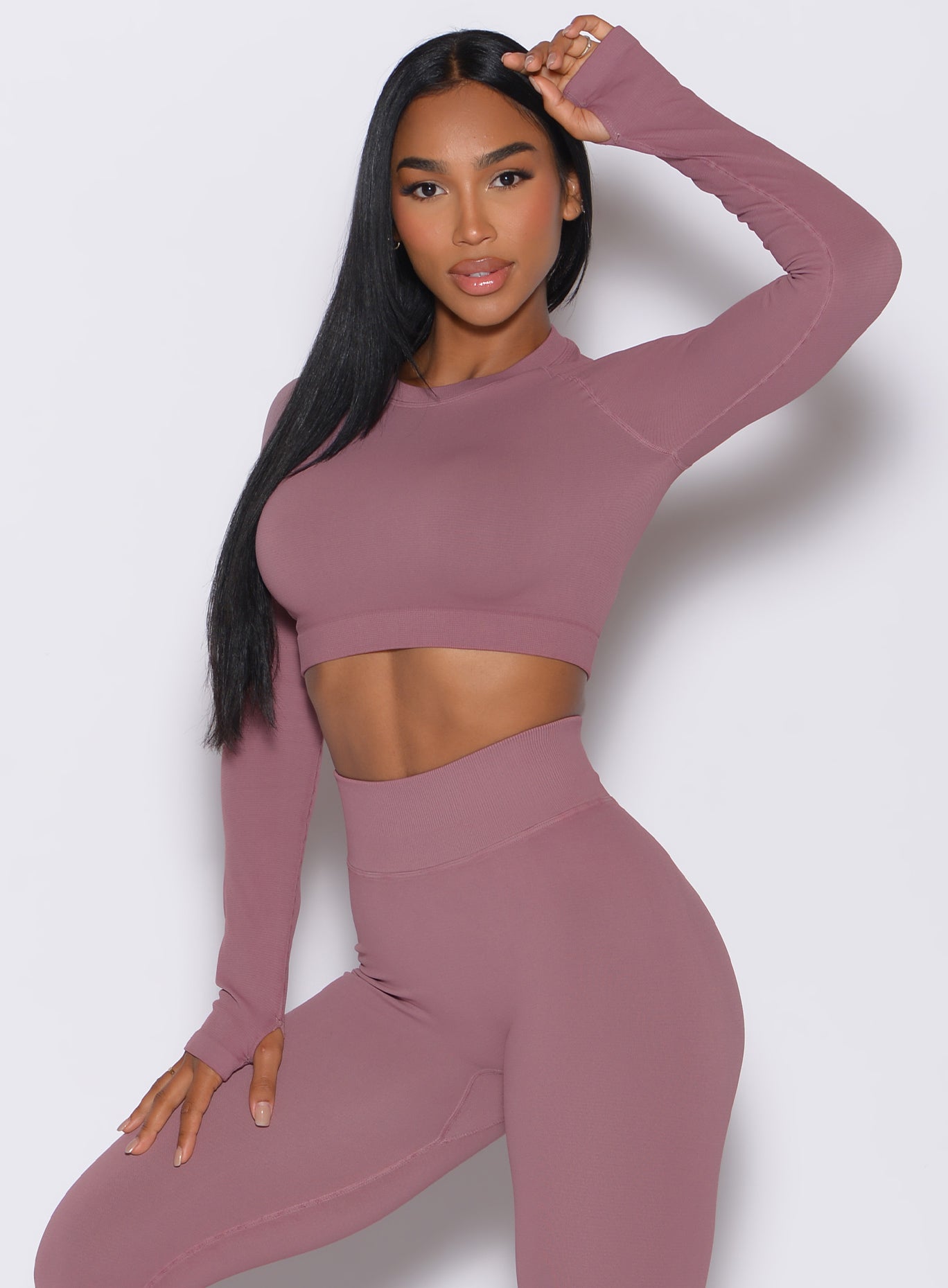 front profile view of a model wearing our seamless pullover in satin color along with a matching leggings