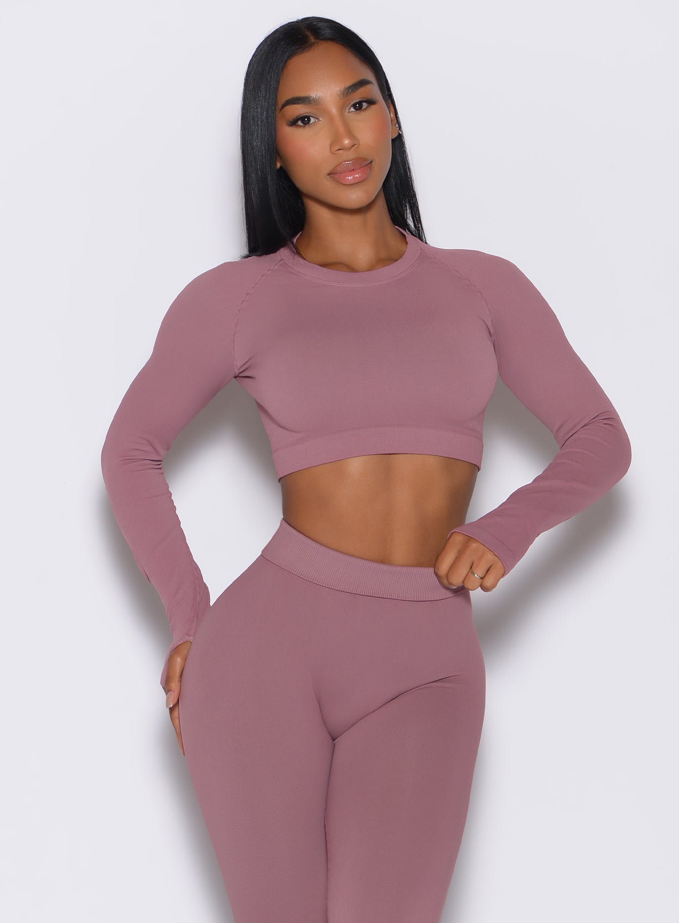 model facing forward wearing our seamless pullover in satin color along with a matching leggings