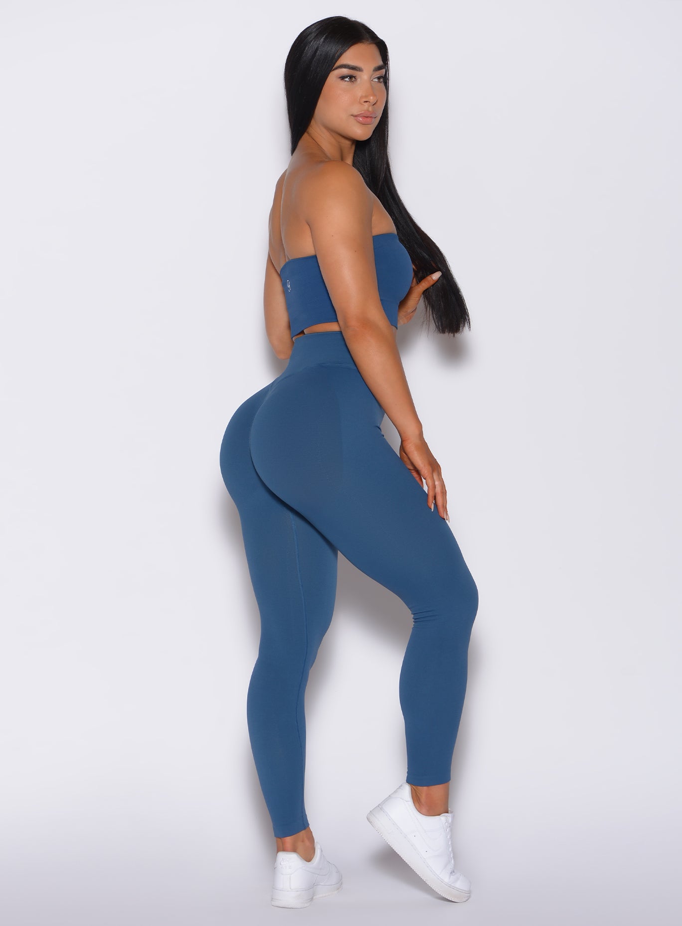 Right profile view of a model wearing our cheeky seamless leggings in galaxy color along with the matching bandeau
