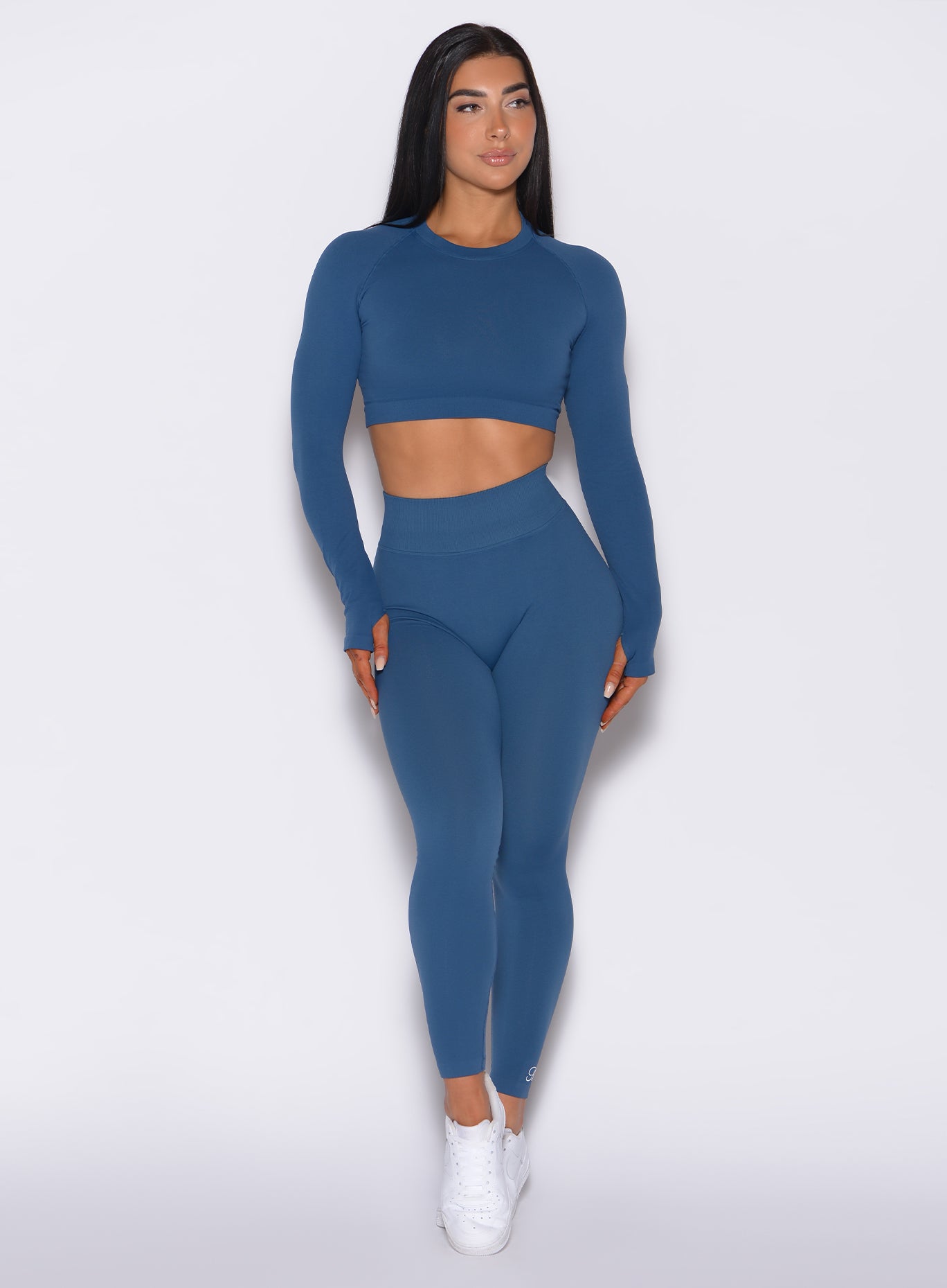 front profile view of a model wearing our cheeky seamless leggings in galaxy color along with the matching pullover