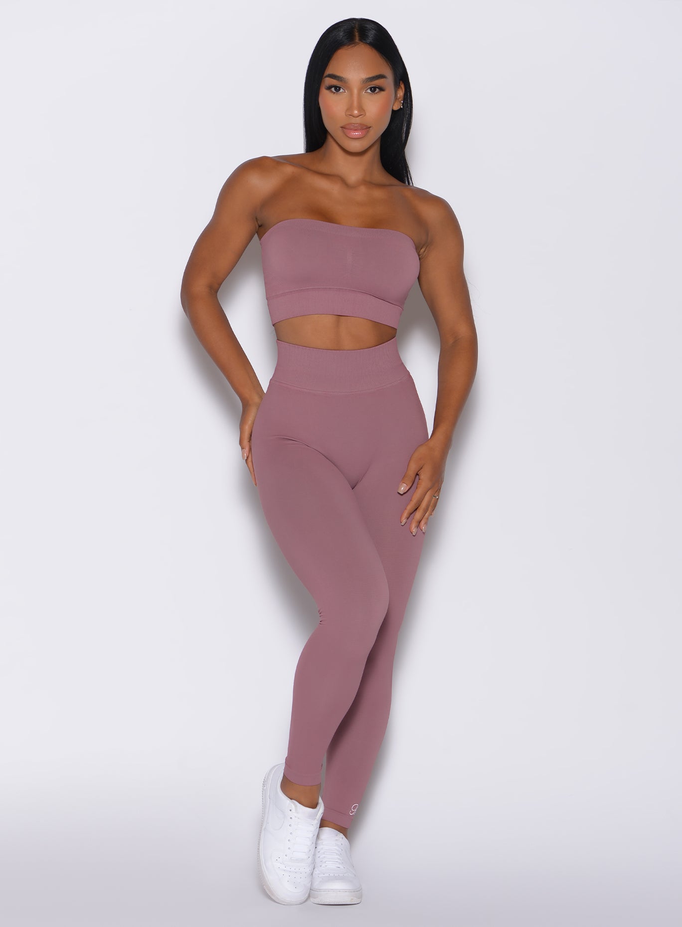 Front profile view of a model wearing our cheeky seamless leggings in satin color along with the matching bandeau