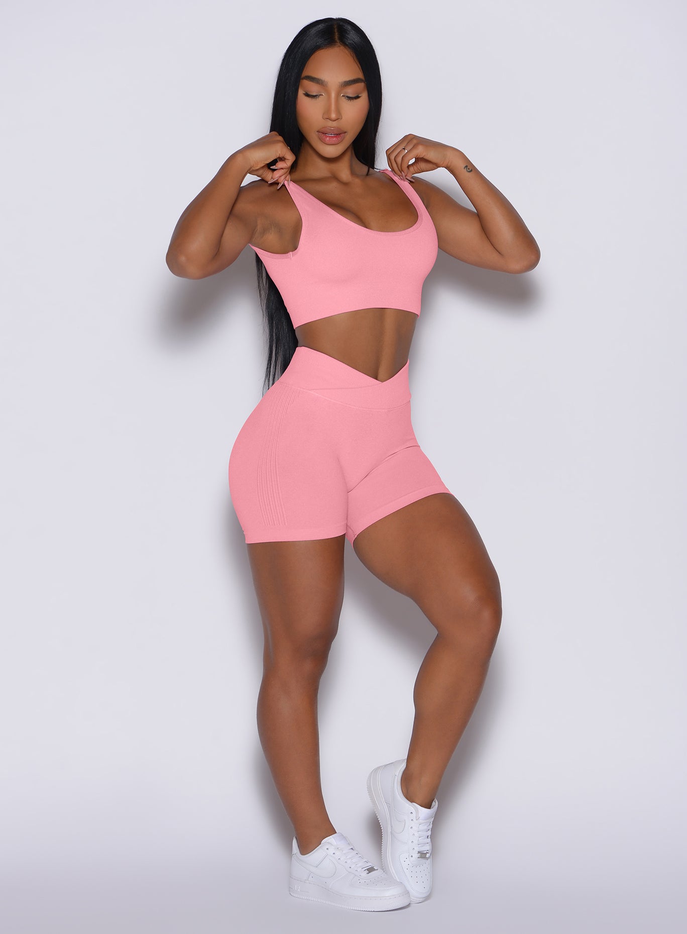 front profile view of a model posing in our Contour Seamless Shorts and the matching Seamless Scoop Bra in Ballerina color