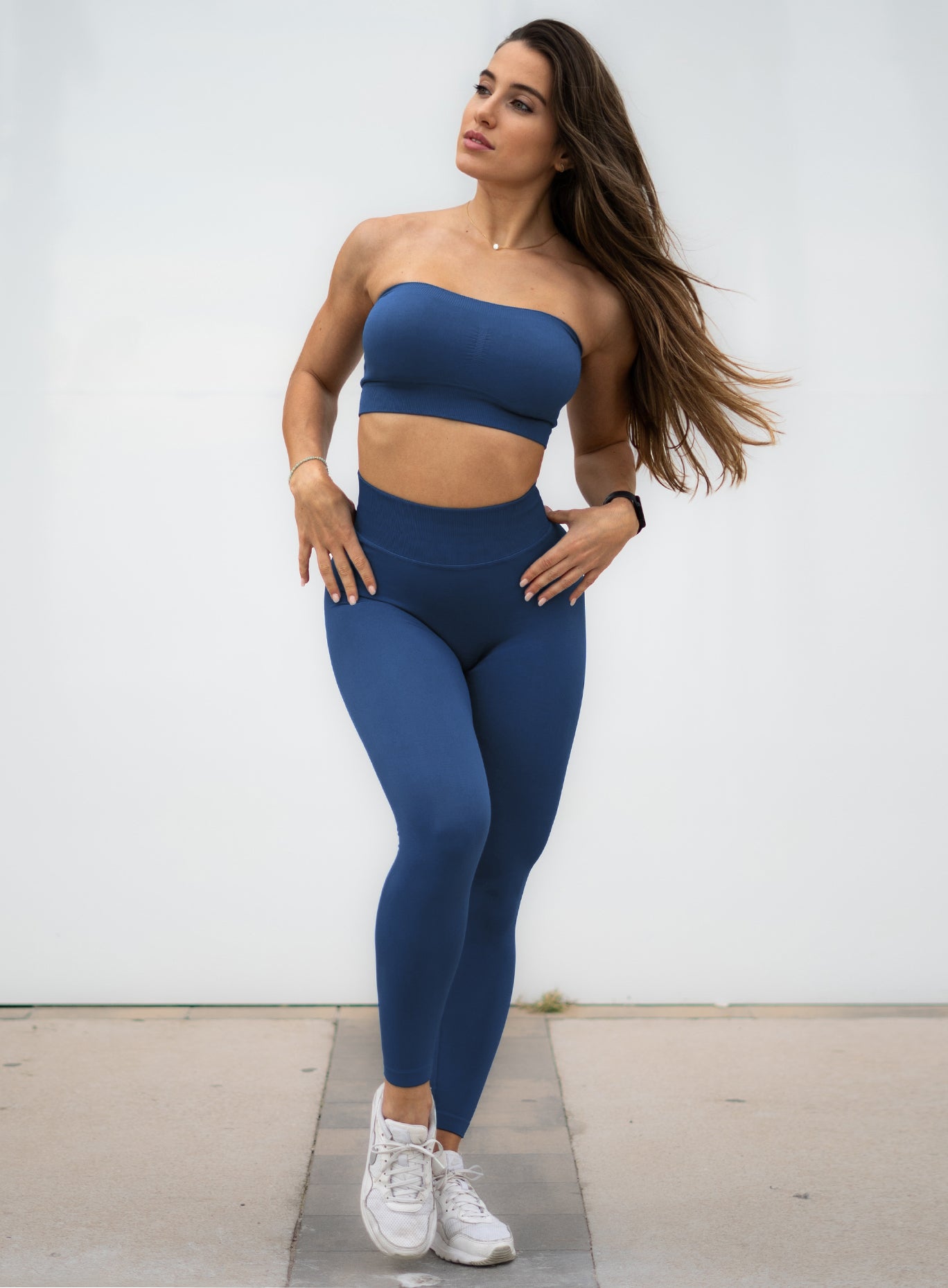 Front profile view of a model wearing our cheeky seamless leggings in galaxy color along with the matching bandeau