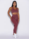 front profile view of a model facing forward wearing the Shimmer V Back Leggings in Ruby star color