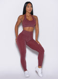 front profile view of a model looking to the left side wearing the Shimmer V Back Leggings in Ruby star color
