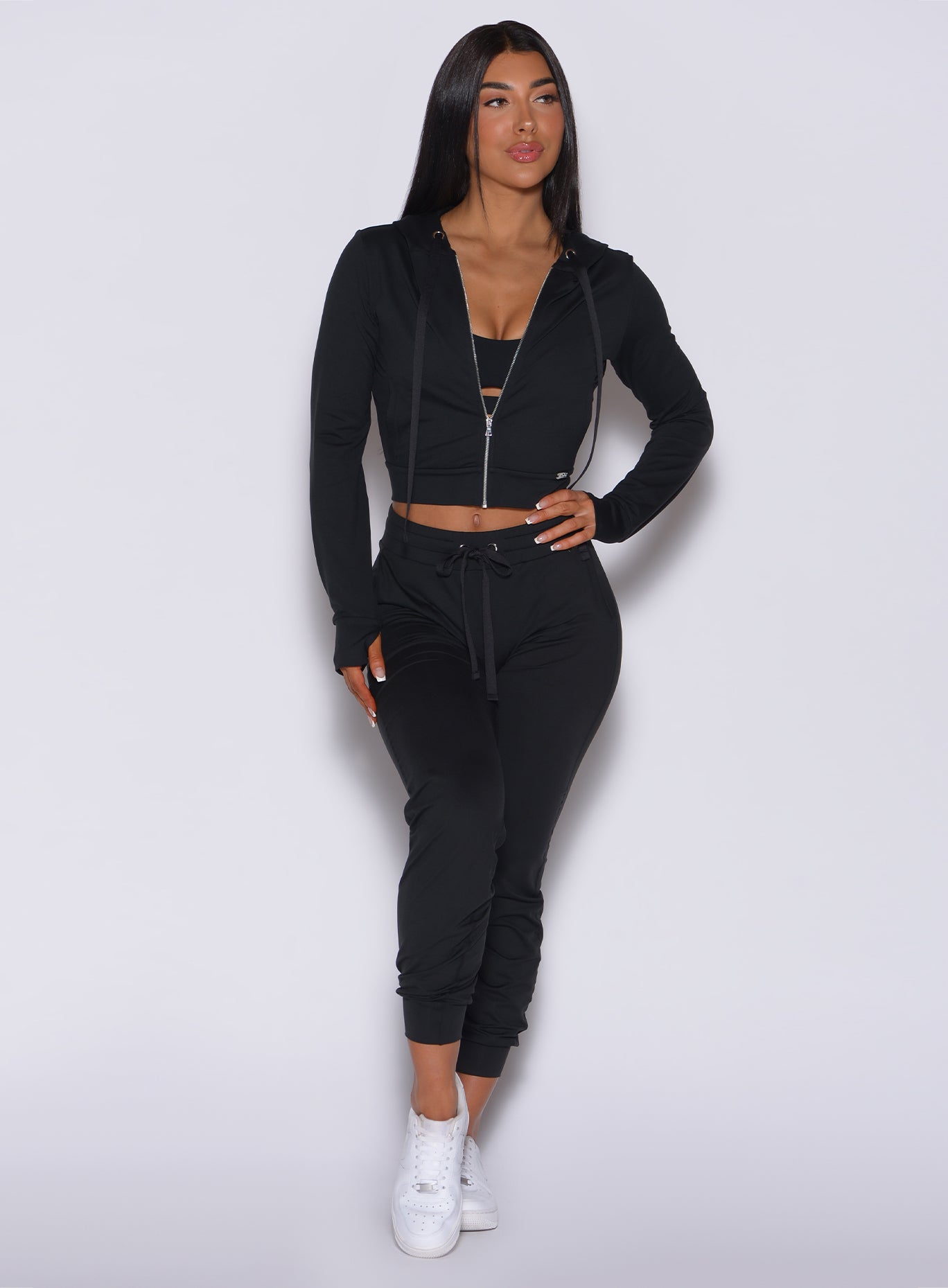 High-waisted black Cozy Joggers and Signature Jacket; a soft, sculpted lounge set for rest days.
