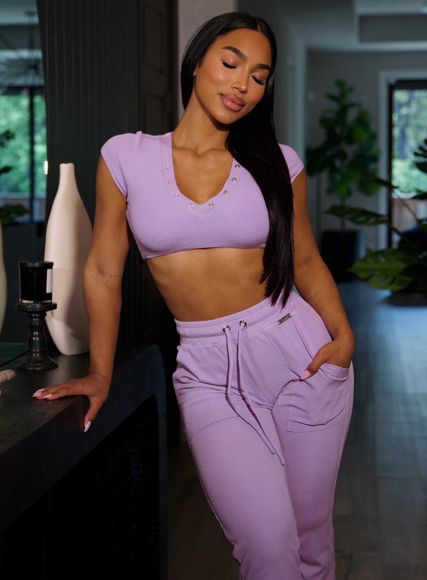 model in indoors wearing the Snap Rib Joggers in Spring Fairy color paired with the matching top