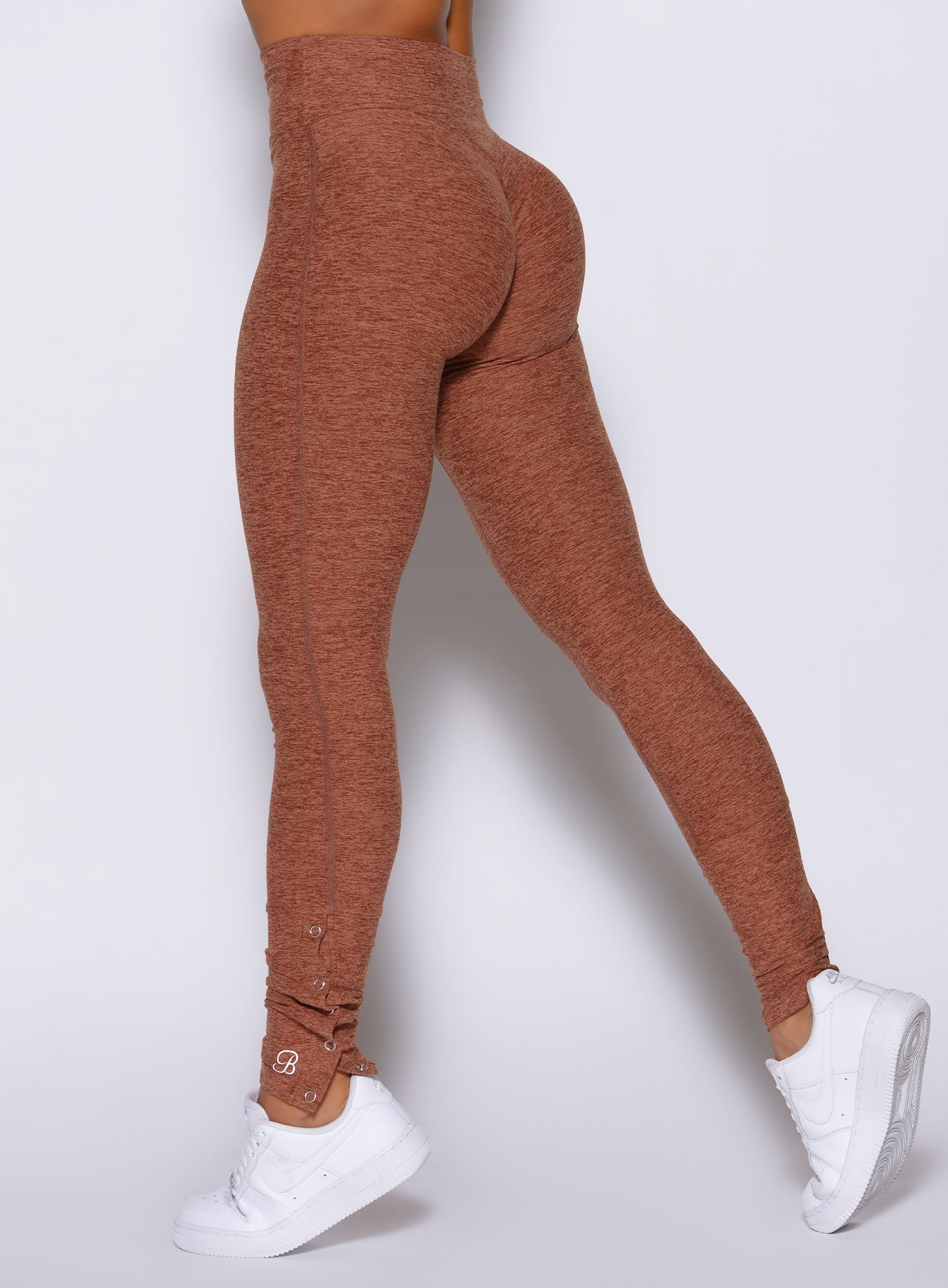 close up back left side view of a model wearing the Snape Flare Leggings in spiced chai color