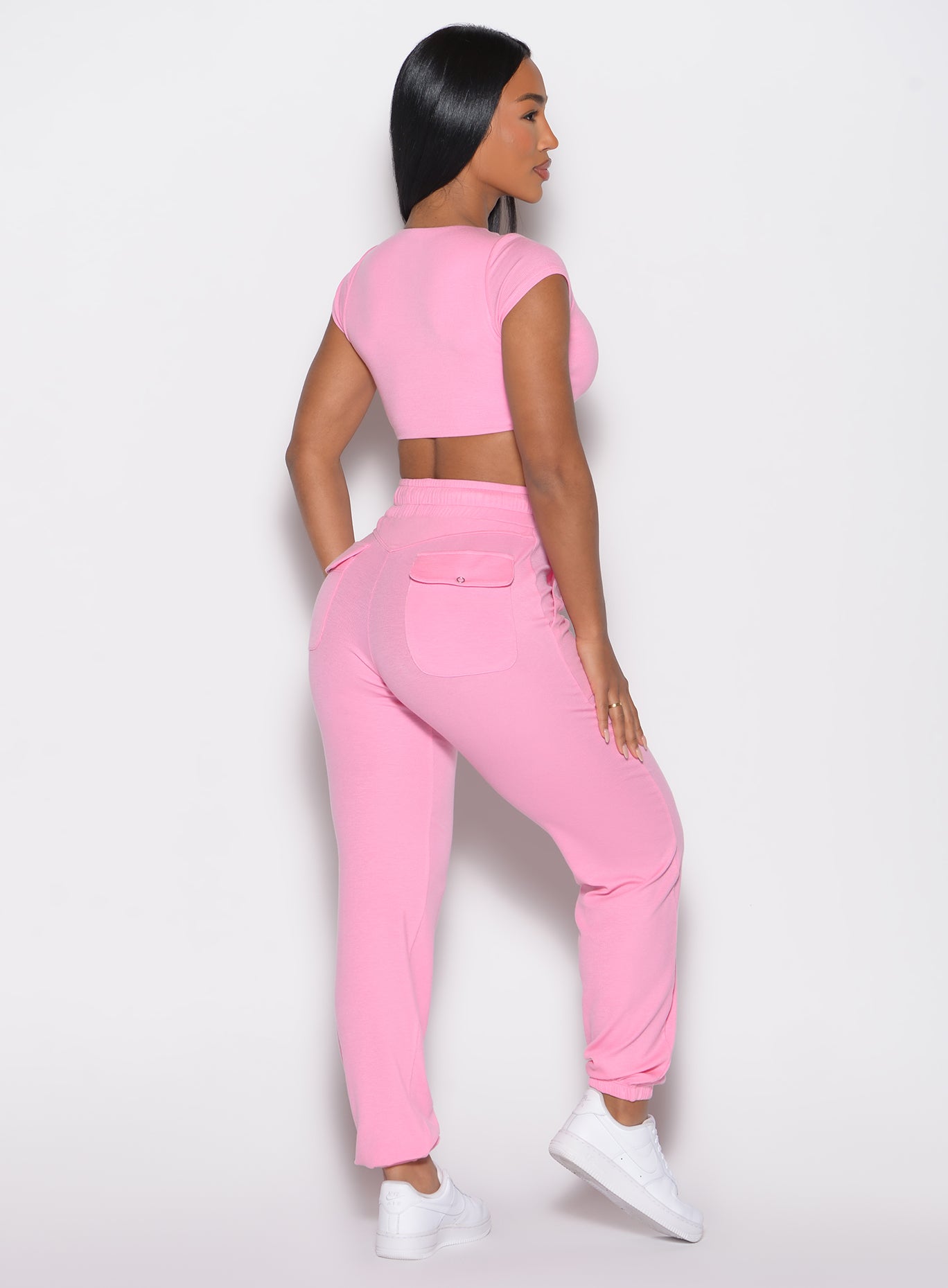 back right side profile view of a model wearing the Snap Rib Joggers in Pink Cupcake color