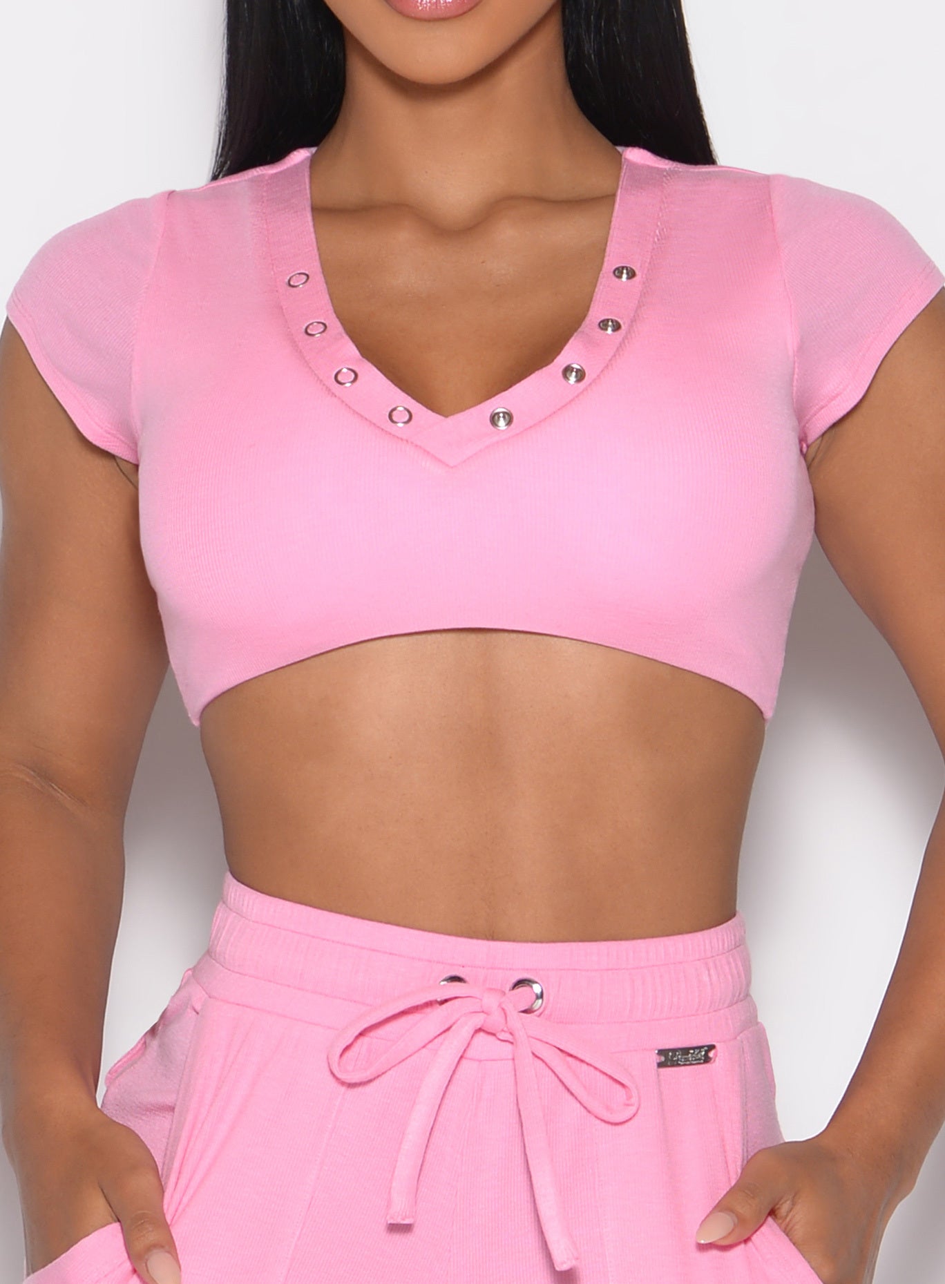 close up front profile view of a model wearing the Snap Top in Pink Cupcake color