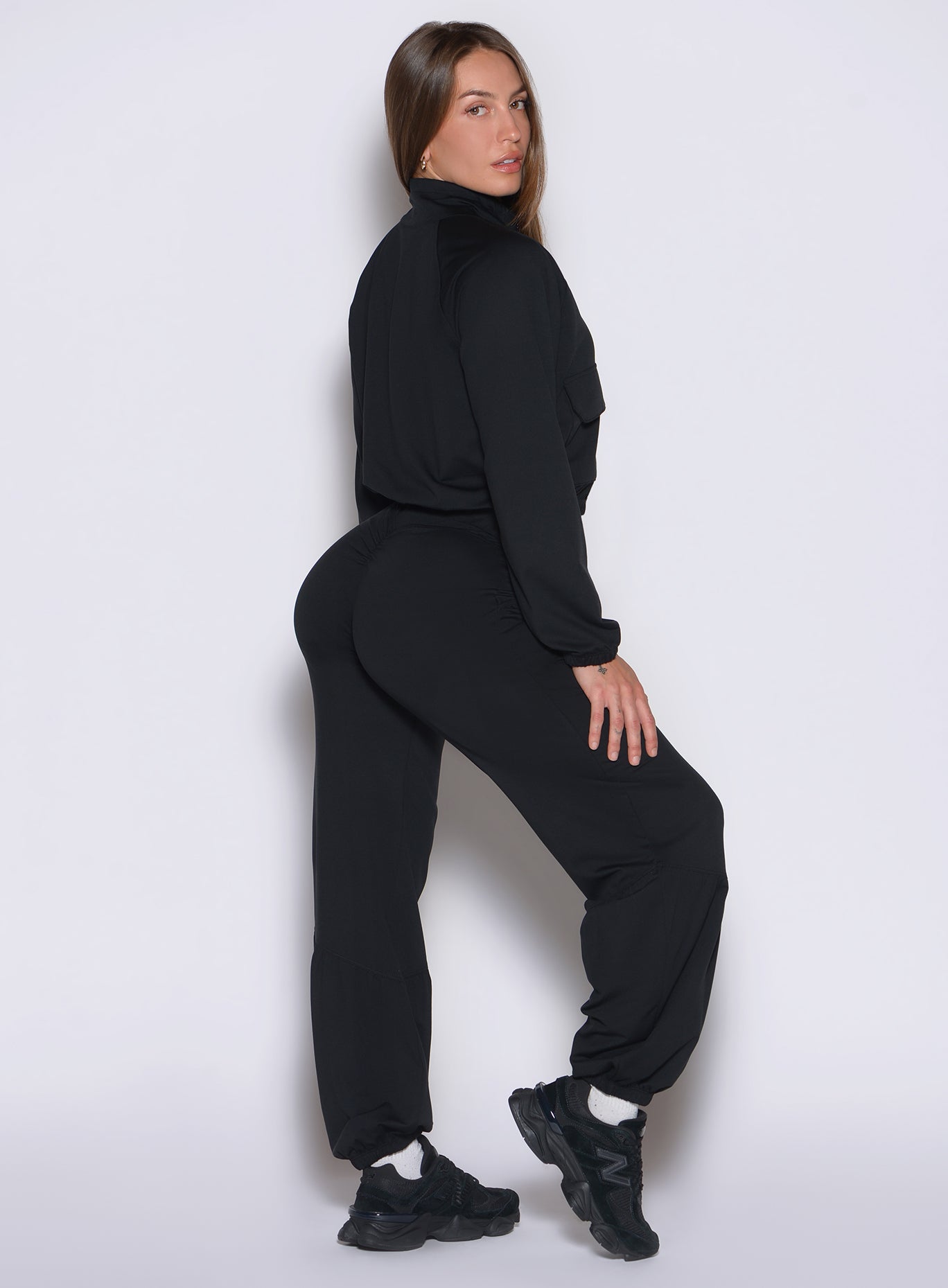 Black Society Joggers in a side profile, featuring a cinched waist and sculpting scrunch detail.