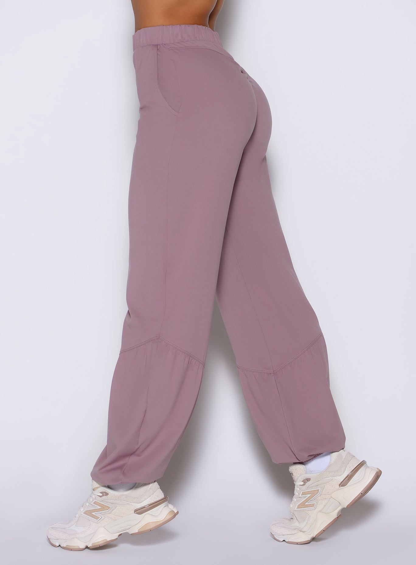close up left side view of a model wearing the Society Joggers in light mauve color