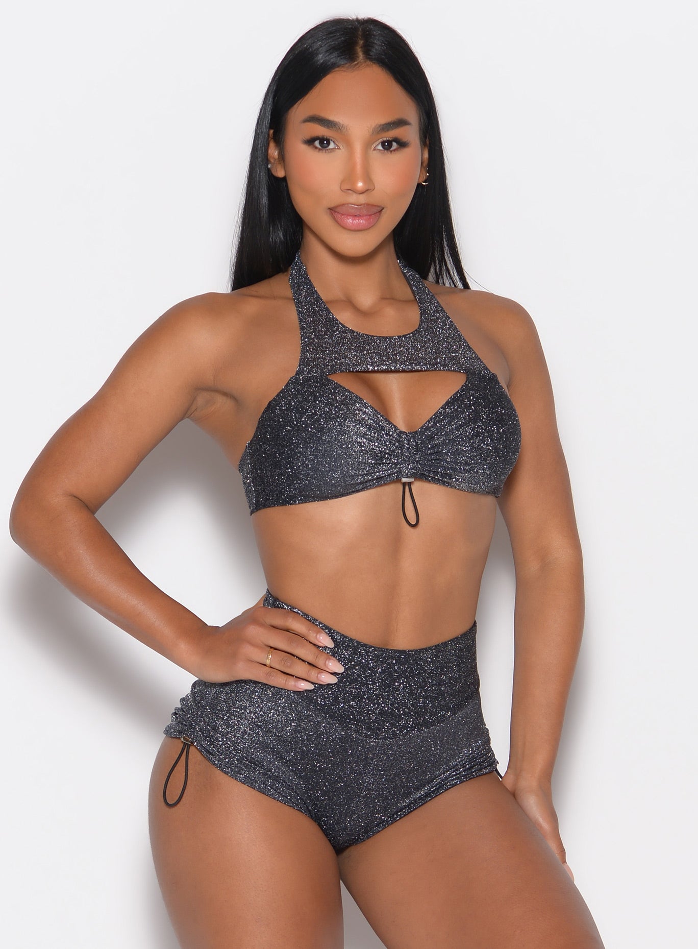 front profile view of a model wearing the Sunkissed Sparkle Bikini Bra in Black Diamond color paired with the matching shorts