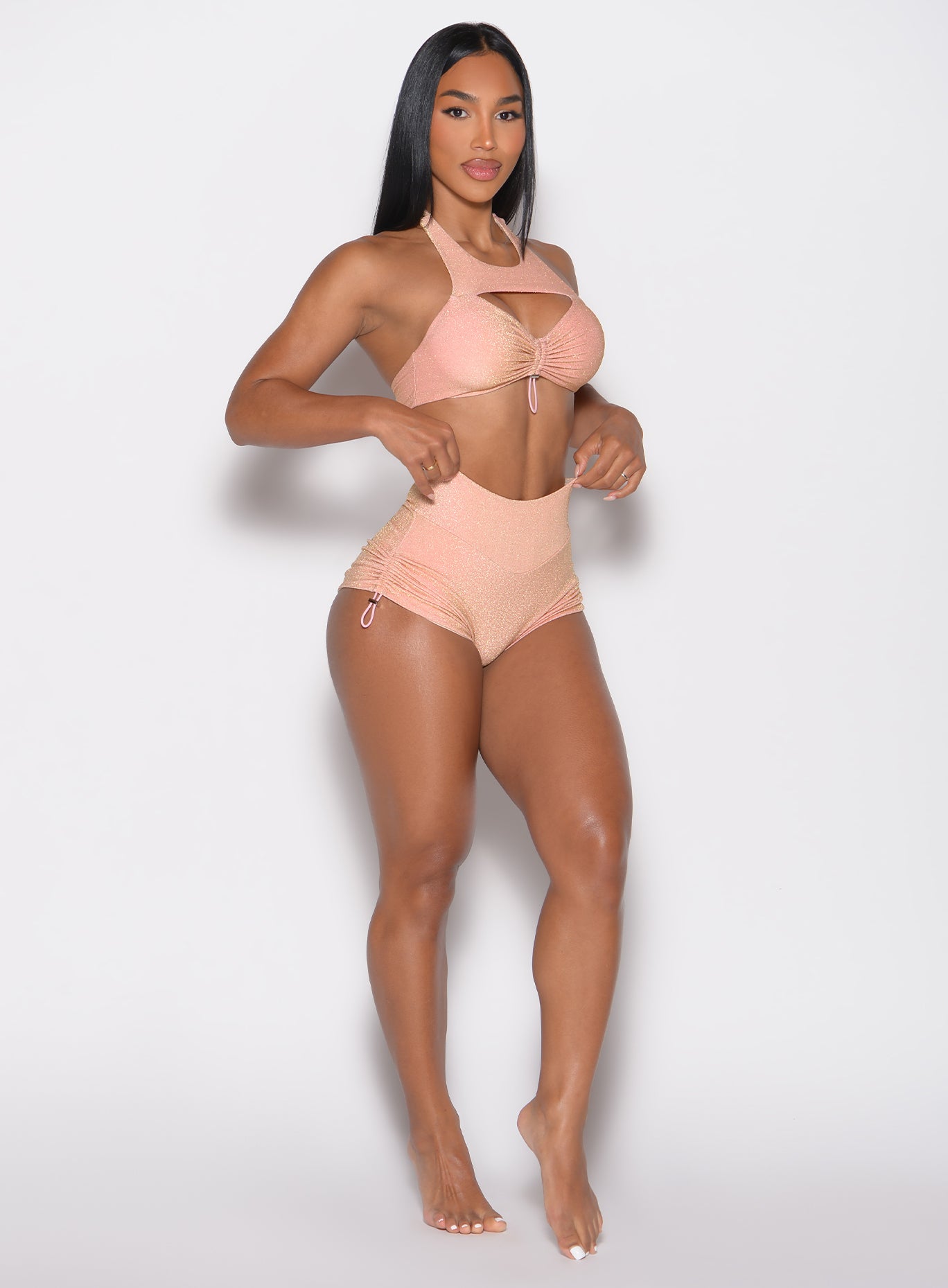 front right side profile view of a model wearing the Sunkissed Sparkle Swim Shorts in Golden Hour color
