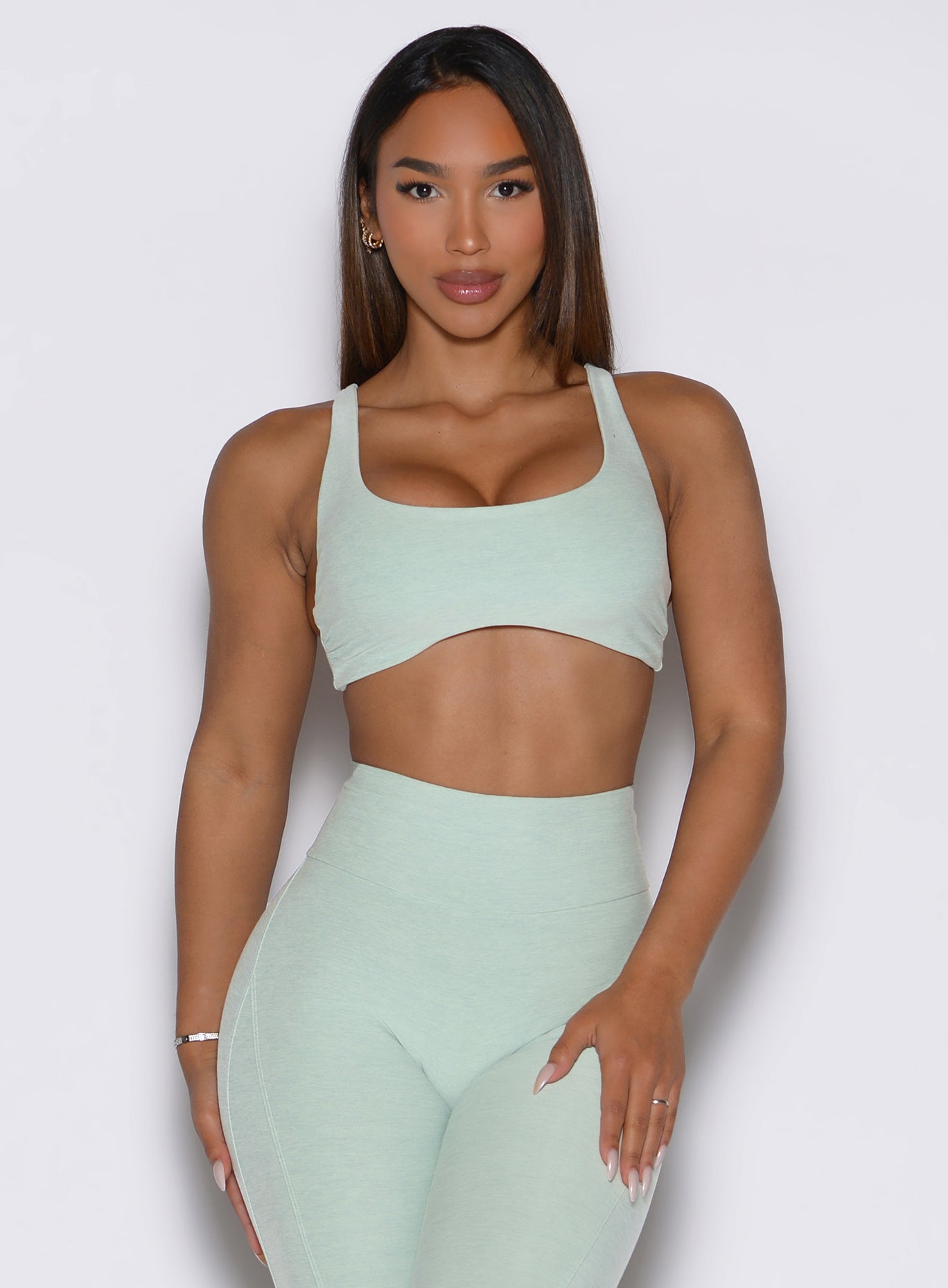Front view of the soft aloe Super Set Bra paired with matching high-waisted sculpting leggings.