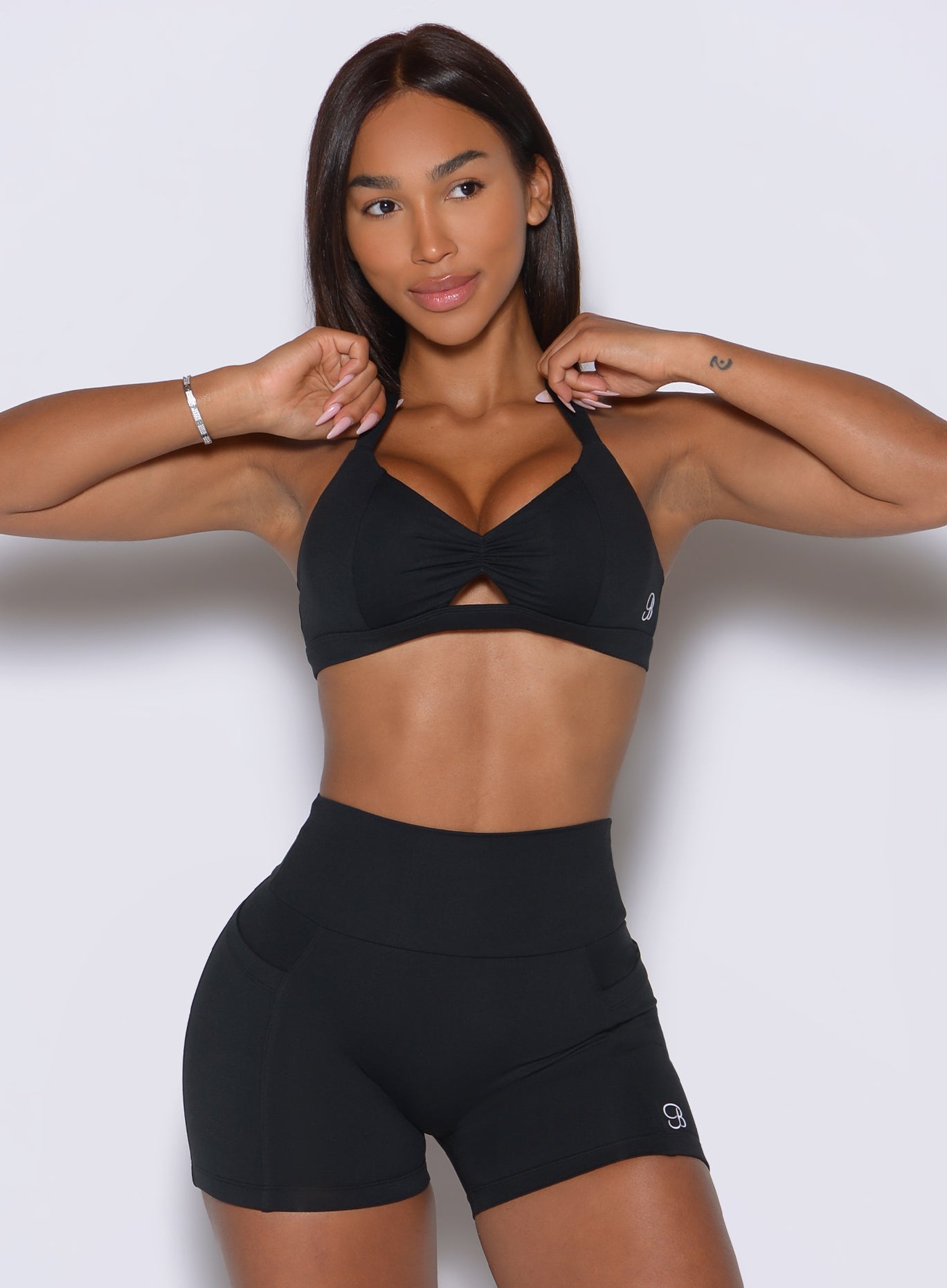 Chic black activewear bra features a scrunched center detail for a defined, comfortable gym fit