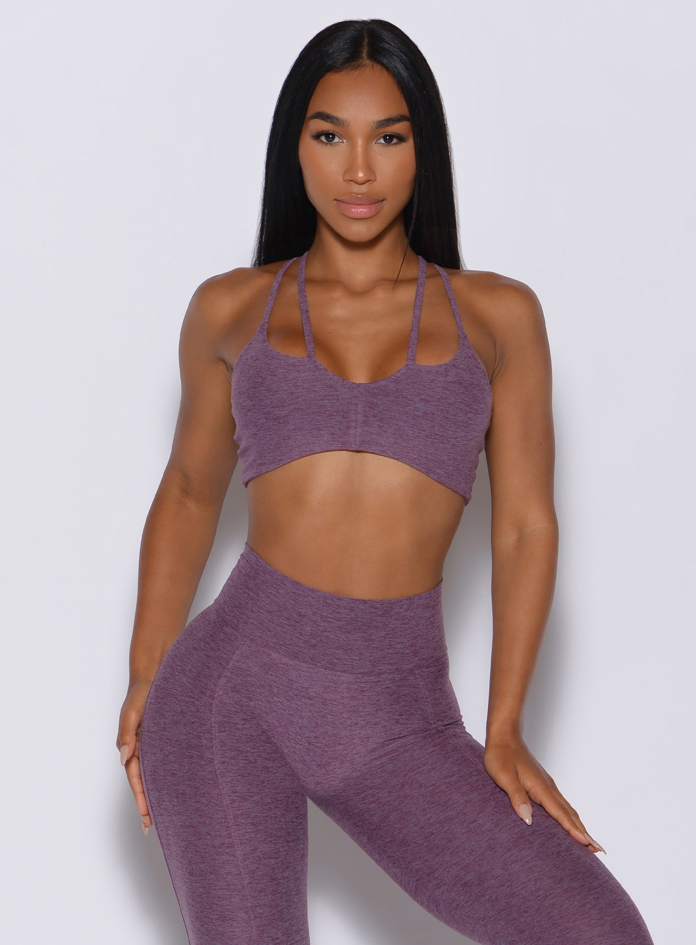 Front profile view of a model wearing our topnotch bra along with the high waisted leggings