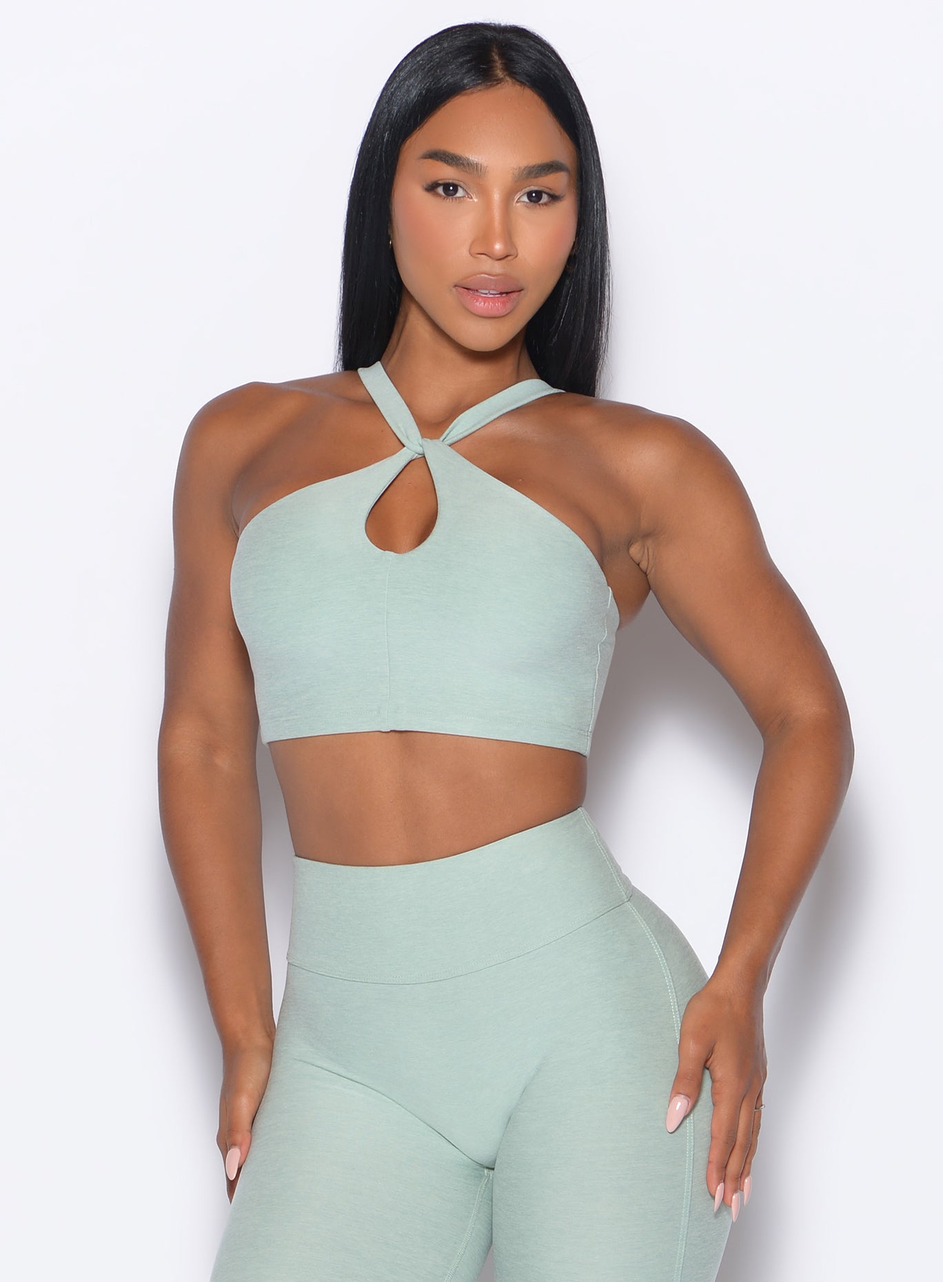 front profile view of our model wearing the Twist Up Bra in soft aloe color