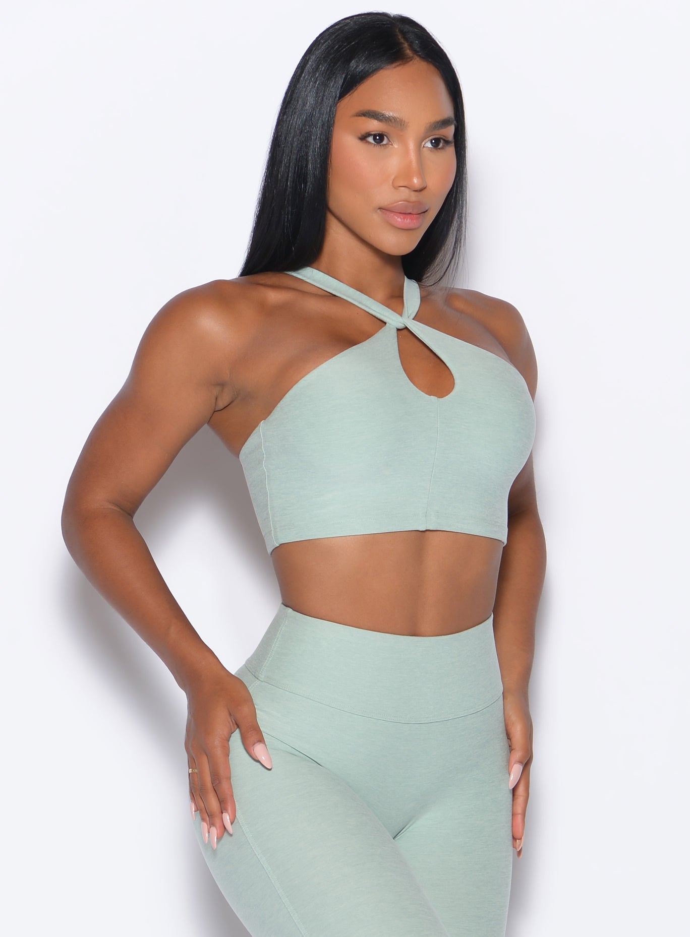 front right side profile view of our model wearing the Twist Up Bra in soft aloe color