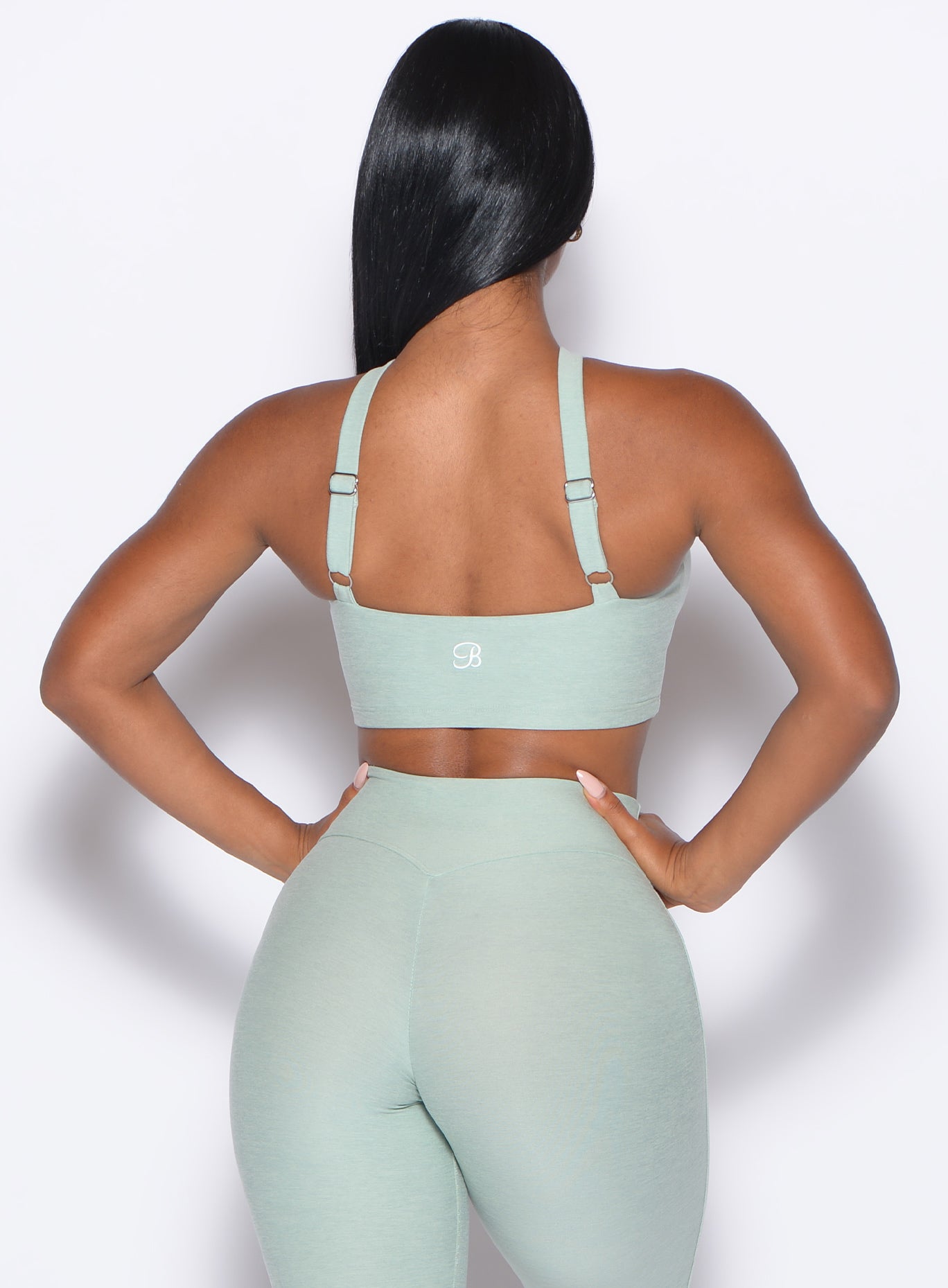 back profile view of our model wearing the Twist Up Bra in soft aloe color