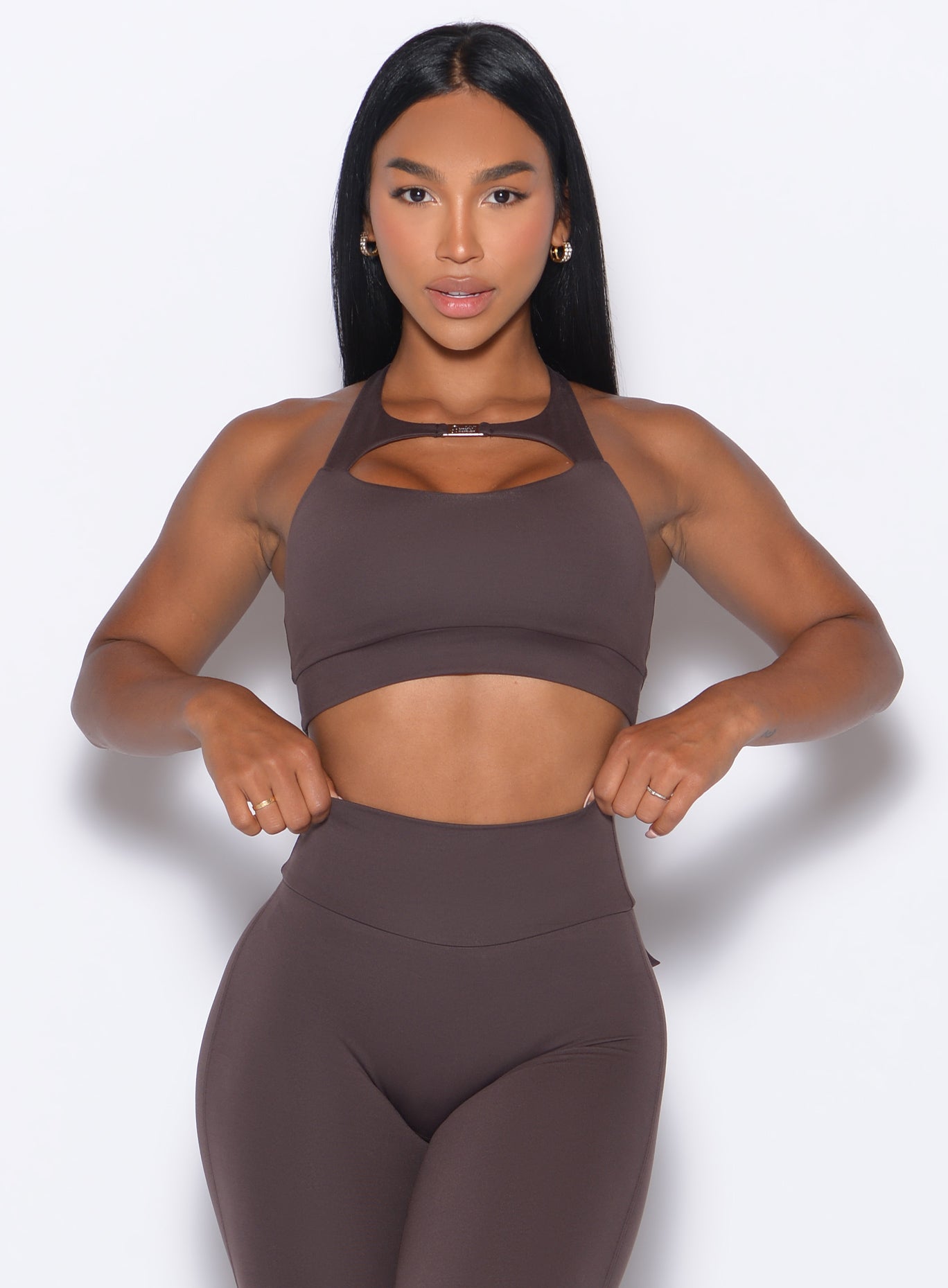 Model facing forward wearing our Two Way Bra in Seal Brown color and a matching leggings