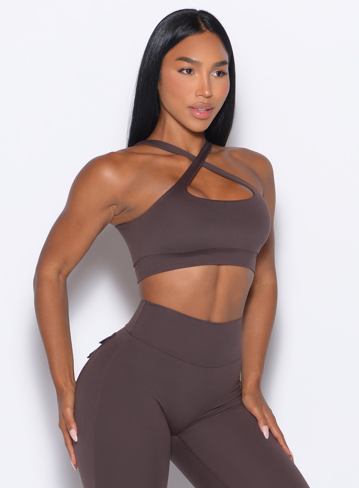 front profile picture of a model in our Two Way Bra in Seal Brown color and a matching leggings