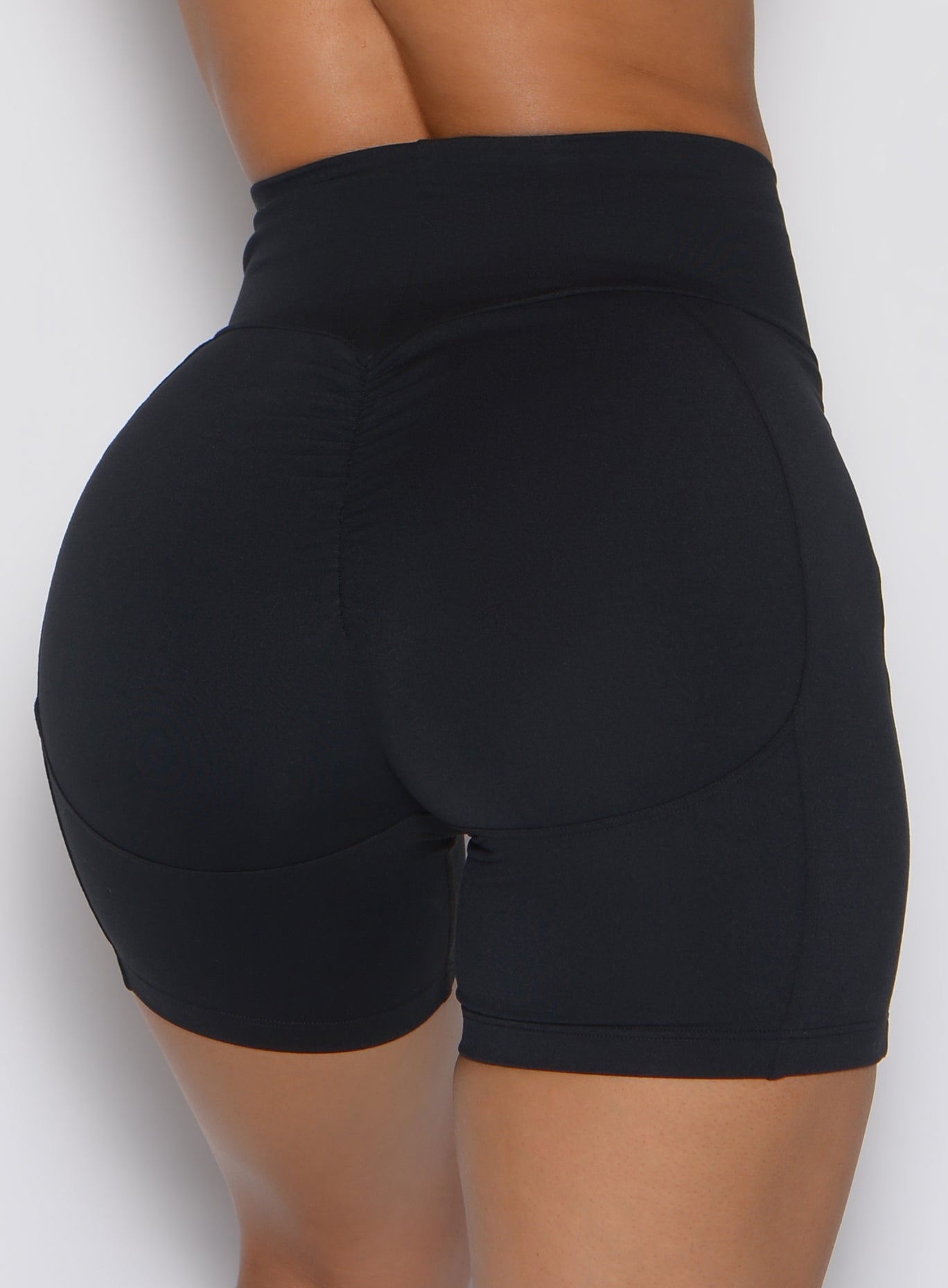 Black Uplift Peach Shorts featuring a sculpting back scrunch seam and high-waisted compression fit.