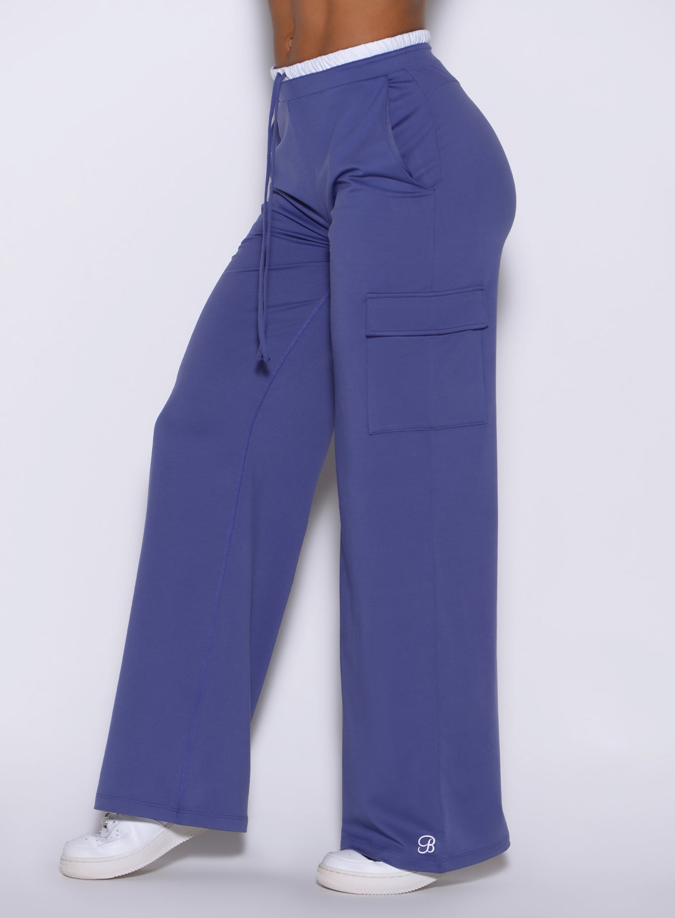 left angle close-up of model wearing Bombshell Sportswear wide leg joggers in Future Dusk color, highlighting relaxed fit and smooth lightweight fabric