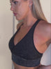 A short video of a model wearing our shimmer seamless leggings set in black sparkle color 