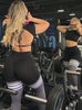 a short video of a model strength training wearing our Scrunch Thigh Highs in Black and Smoke color along with a white sports bra 