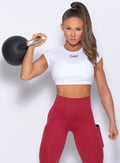 Front profile view of the model in a white tee