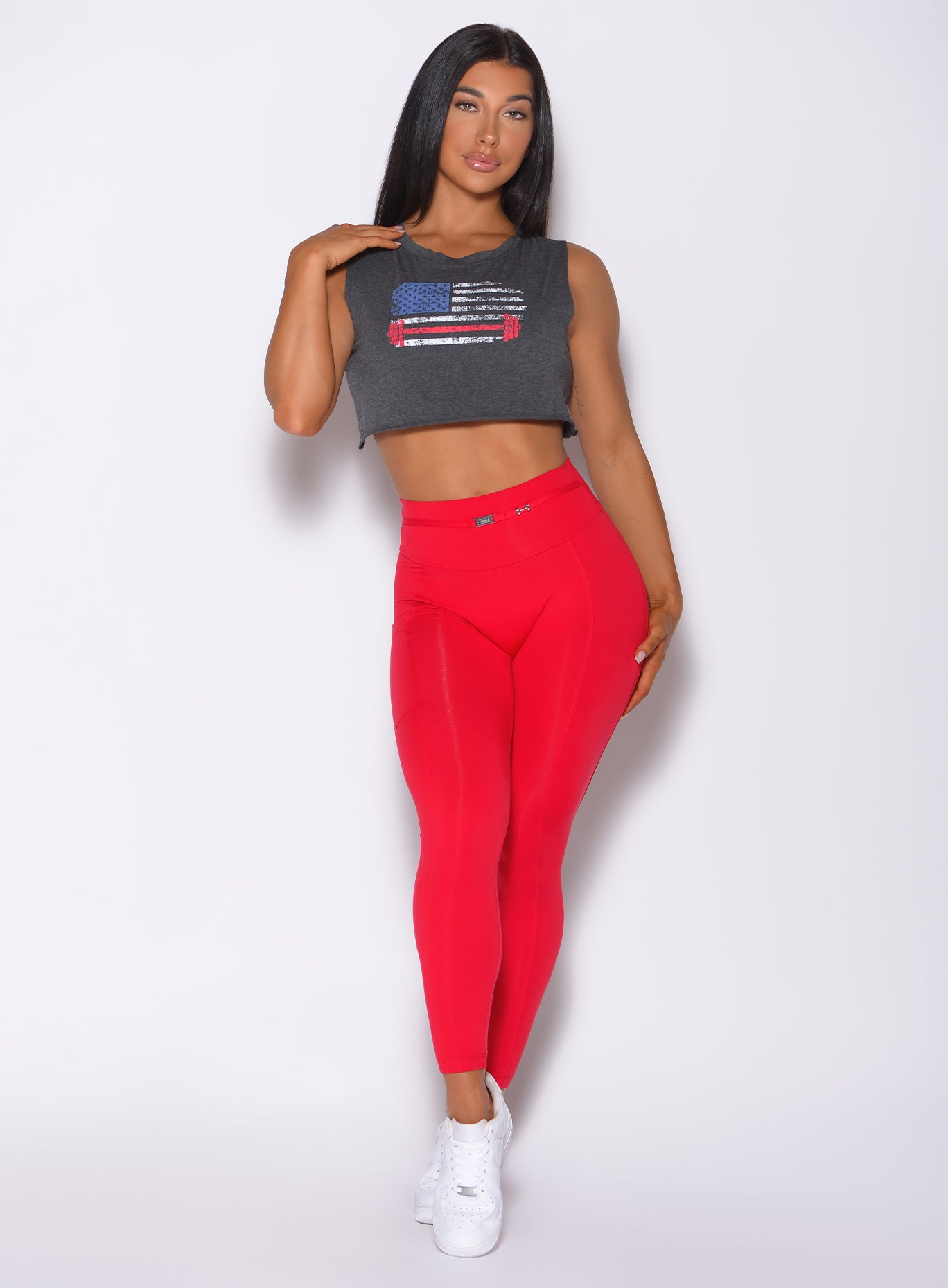 Front profile view of a model in our red barbell leggings and a gray tee