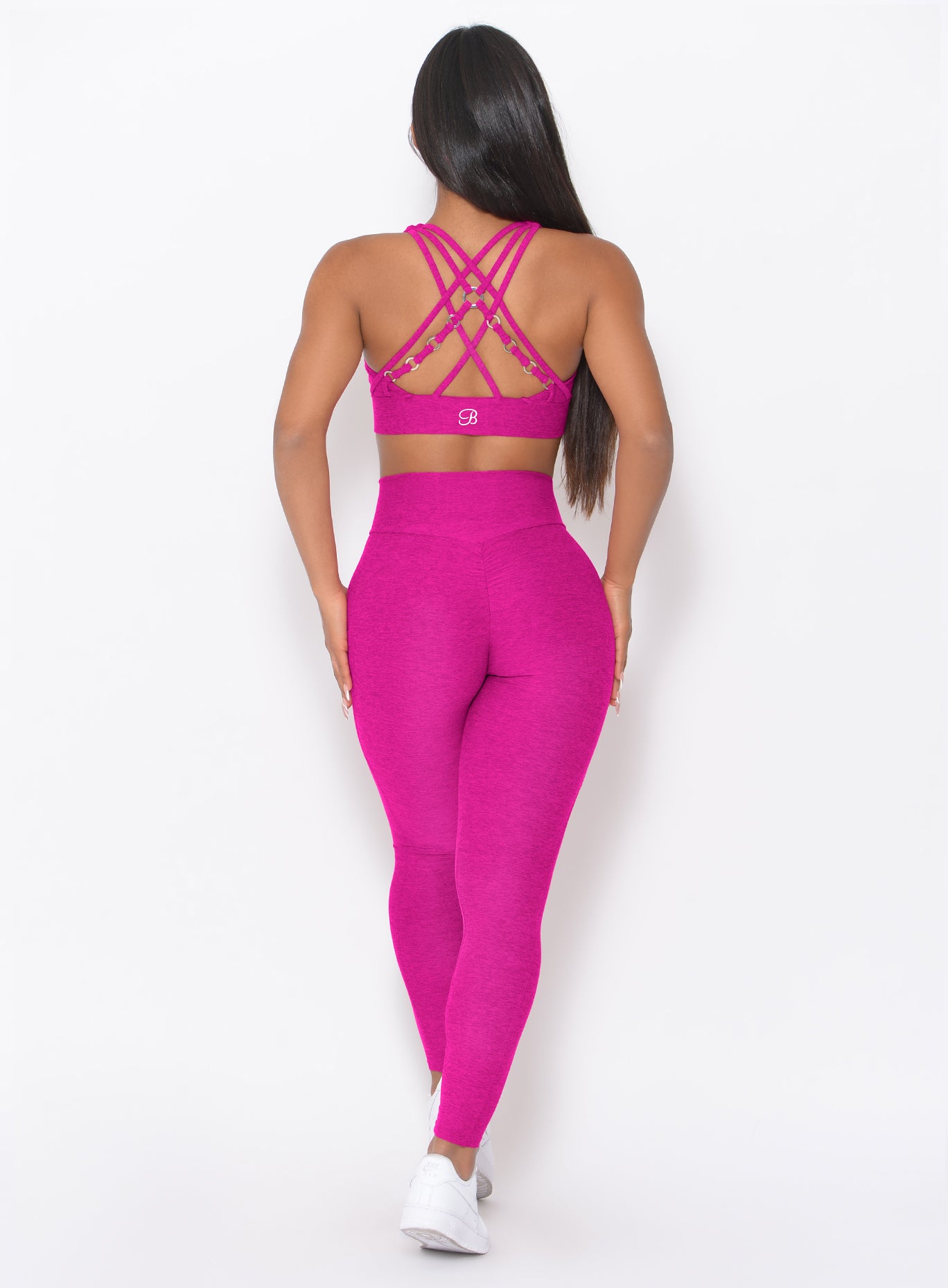 Sculpted back view of Ultra Pink Contour Leggings with a V-cut waistband and booty scrunch seam.