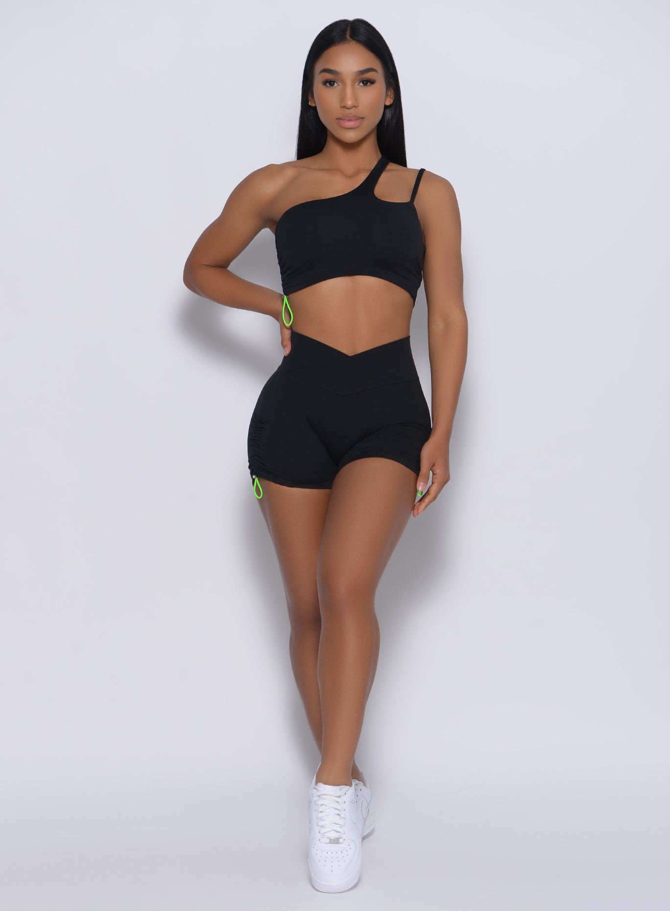 Black high-waisted Contour Toggle Shorts with neon green side pulls for a custom, sculpted fit.