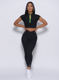 Model facing forward wearing our Brazilian 7/8 Leggings in Black color and a matching top