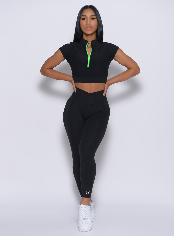 Model facing forward wearing our Brazilian 7/8 Leggings in Black color and a matching top