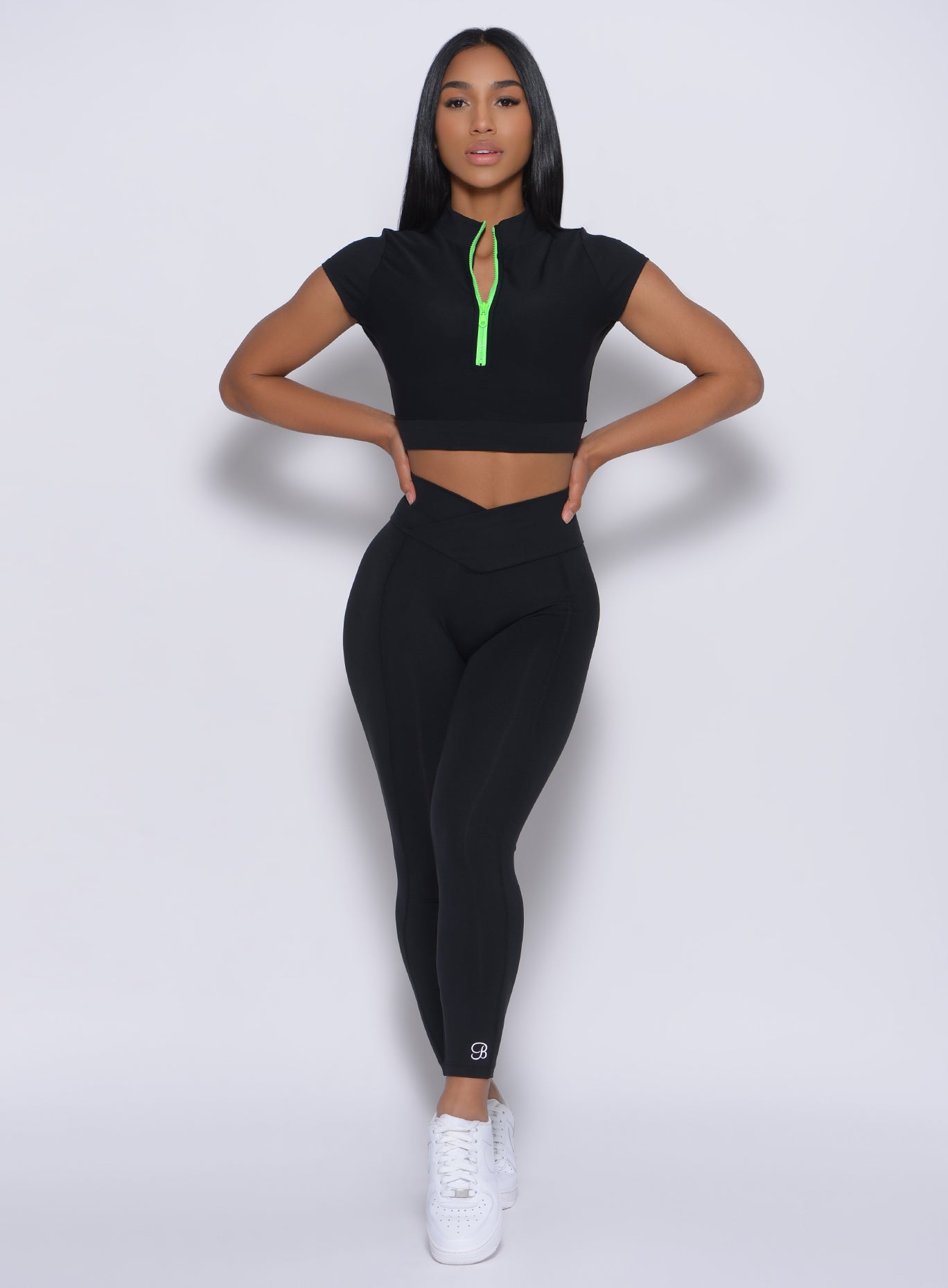 Model facing forward wearing our Brazilian 7/8 Leggings in Black color and a matching top