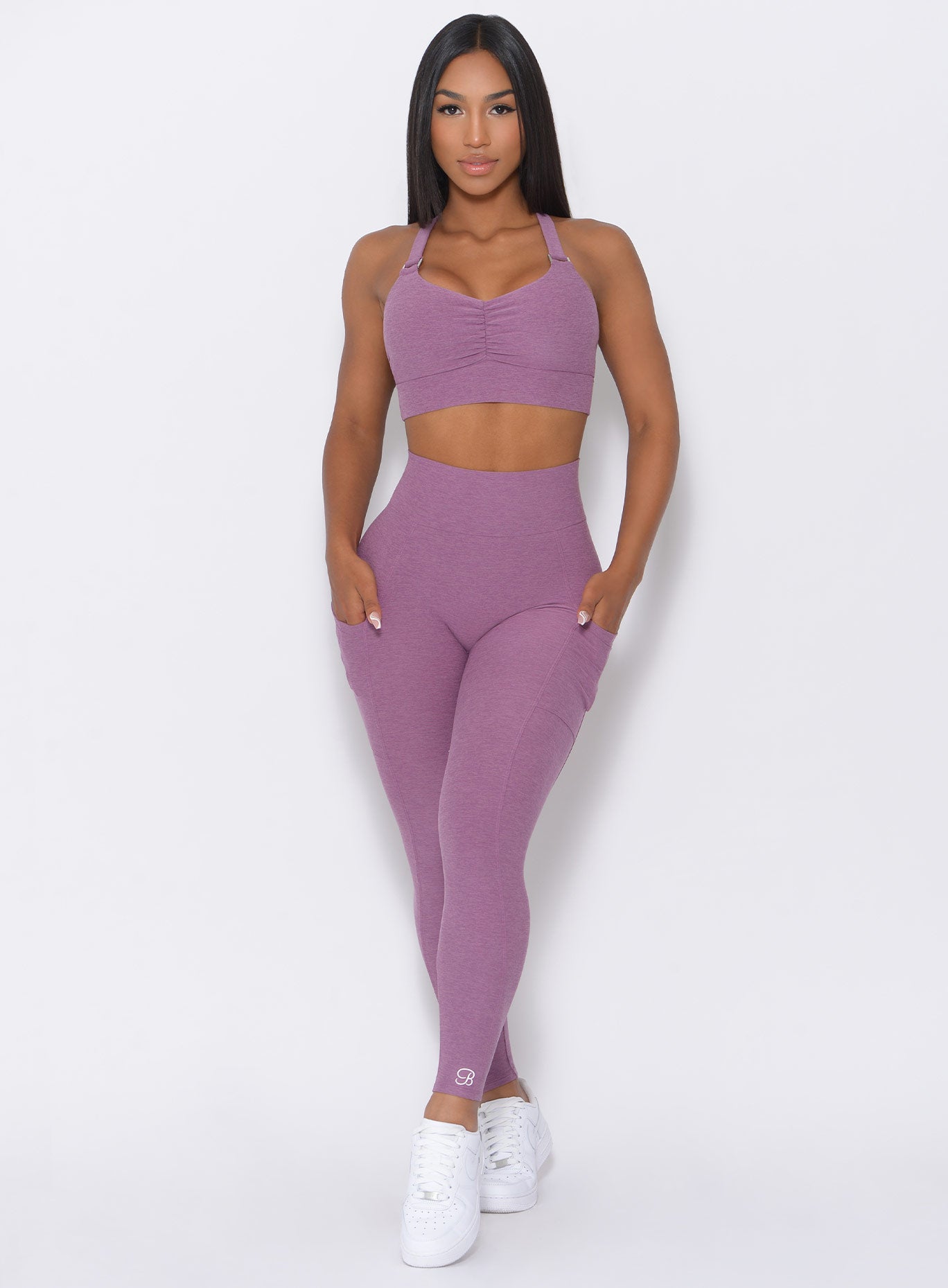 Front profile of the model in our lavender curves high waist leggings  and a matching bra 
