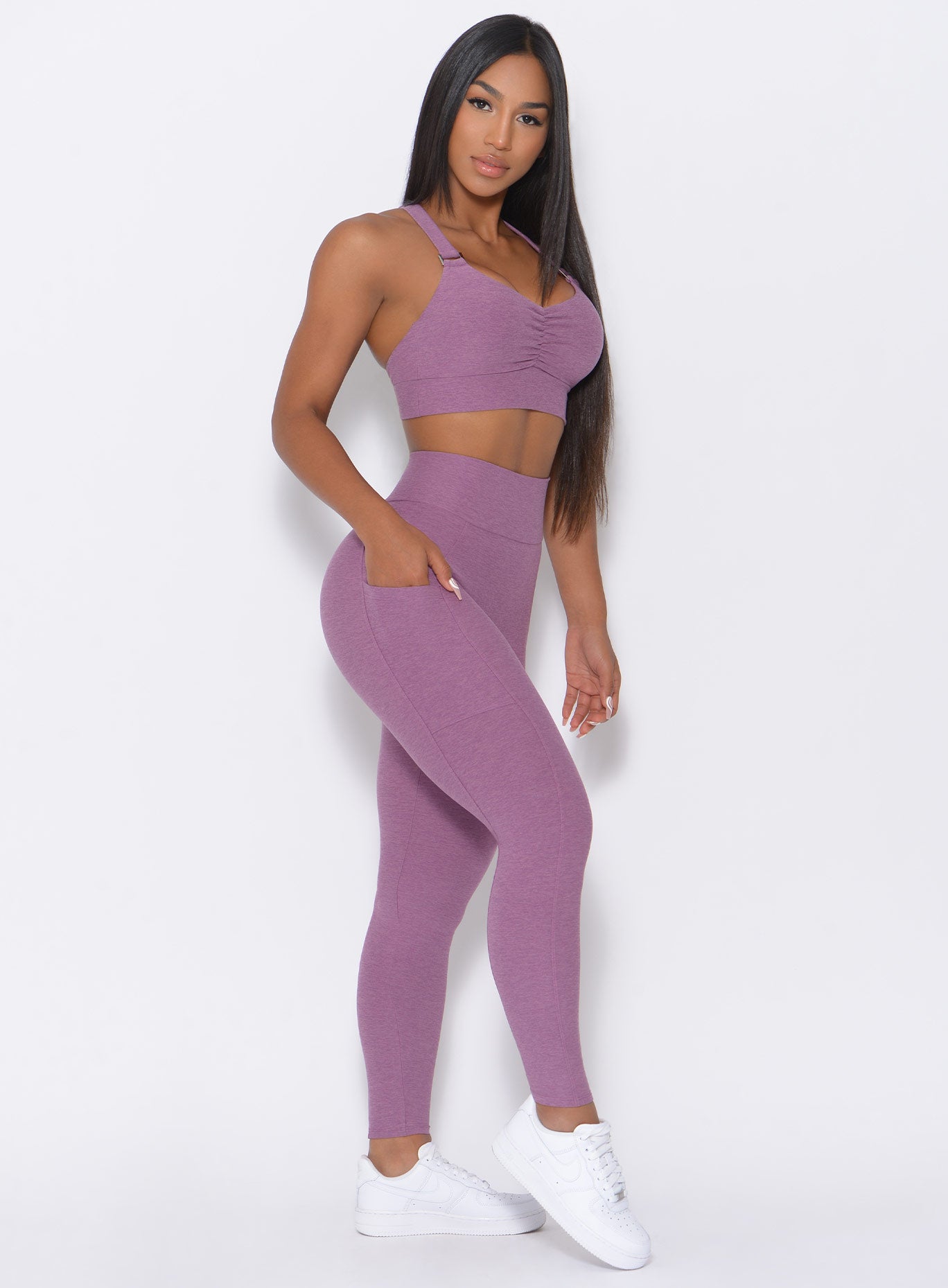 Right side view of the model in our lavender curves high waist leggings and a matching bra
