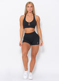 Model facing forward in our black curves shorts and a matching bra