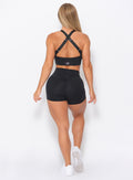 Back view of the model in our black curves shorts and a matching bra