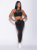 Front profile view of a model wearing our black Mohawk leggings and a matching bra
