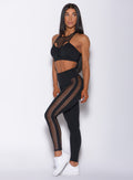 Front profile view of a model in our black Mohawk leggings and a matching bra