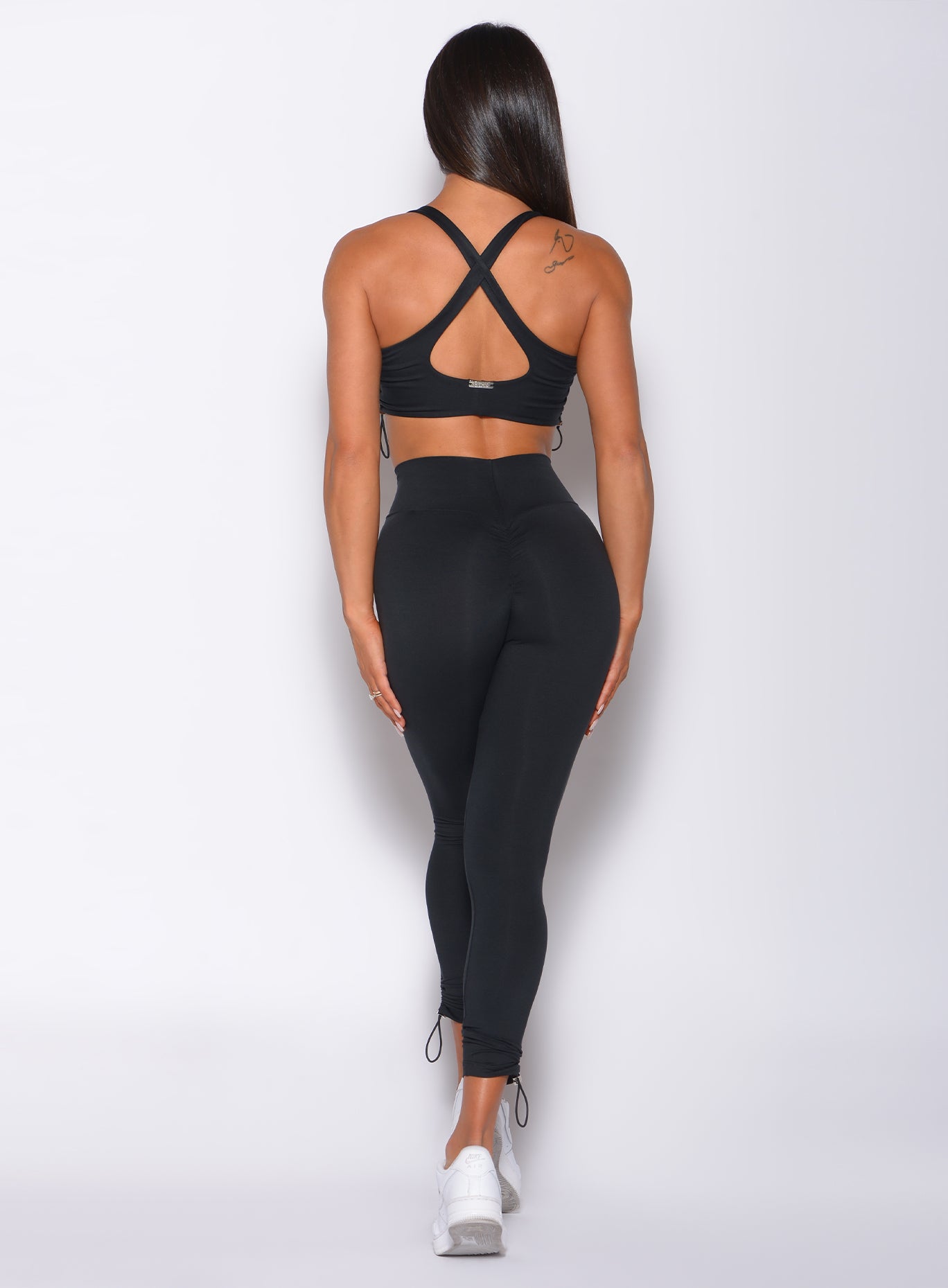 Black Contour Toggle Leggings featuring an adjustable V-waist for a sculpted gym look.
